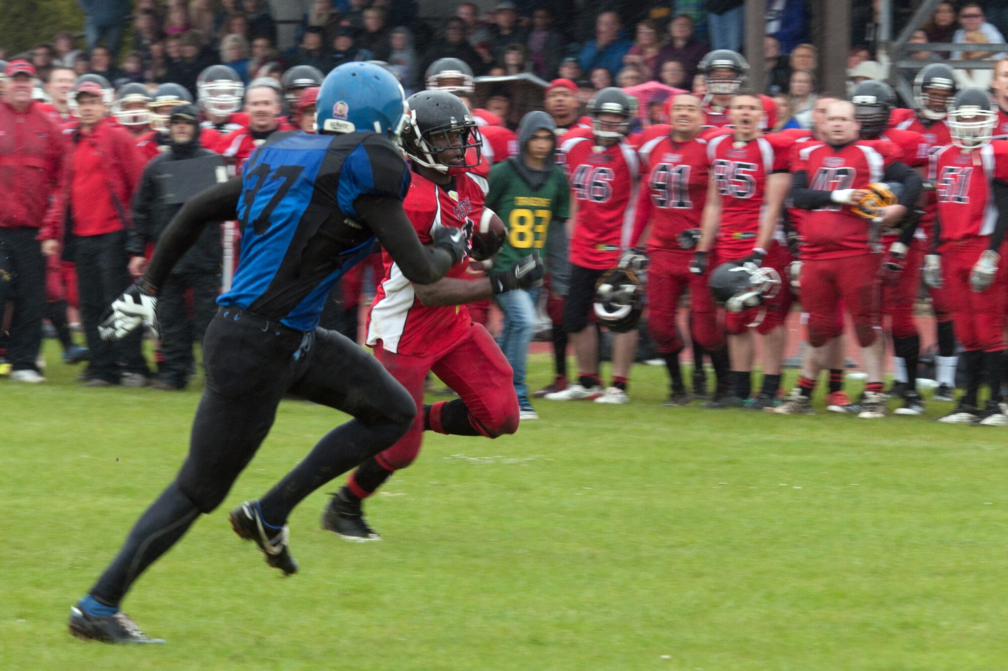 RAF ALCONBURY, United Kingdom – Octavius Ellis, Cambridgeshire Cats running back, runs past Kevin Cunningham, Peterborough Saxons defensive back, for a touchdown in the third quarter of the first ever Bob "The Dog" Shaw Classic May 12 at the RAF Alconbury football field. These two teams have a history of playing each other for years and consider each other rivals. Both teams also have military personnel from RAF Alconbury, RAF Molesworth, RAF Mildenhall and RAF Lakenheath playing alongside British players. Coach Bob Shaw was a part of both teams as an offensive line coach for both the Saxons and Cats, and was the head coach for the Cats. (U.S. Air Force photo by Staff Sgt. Brian Stives)