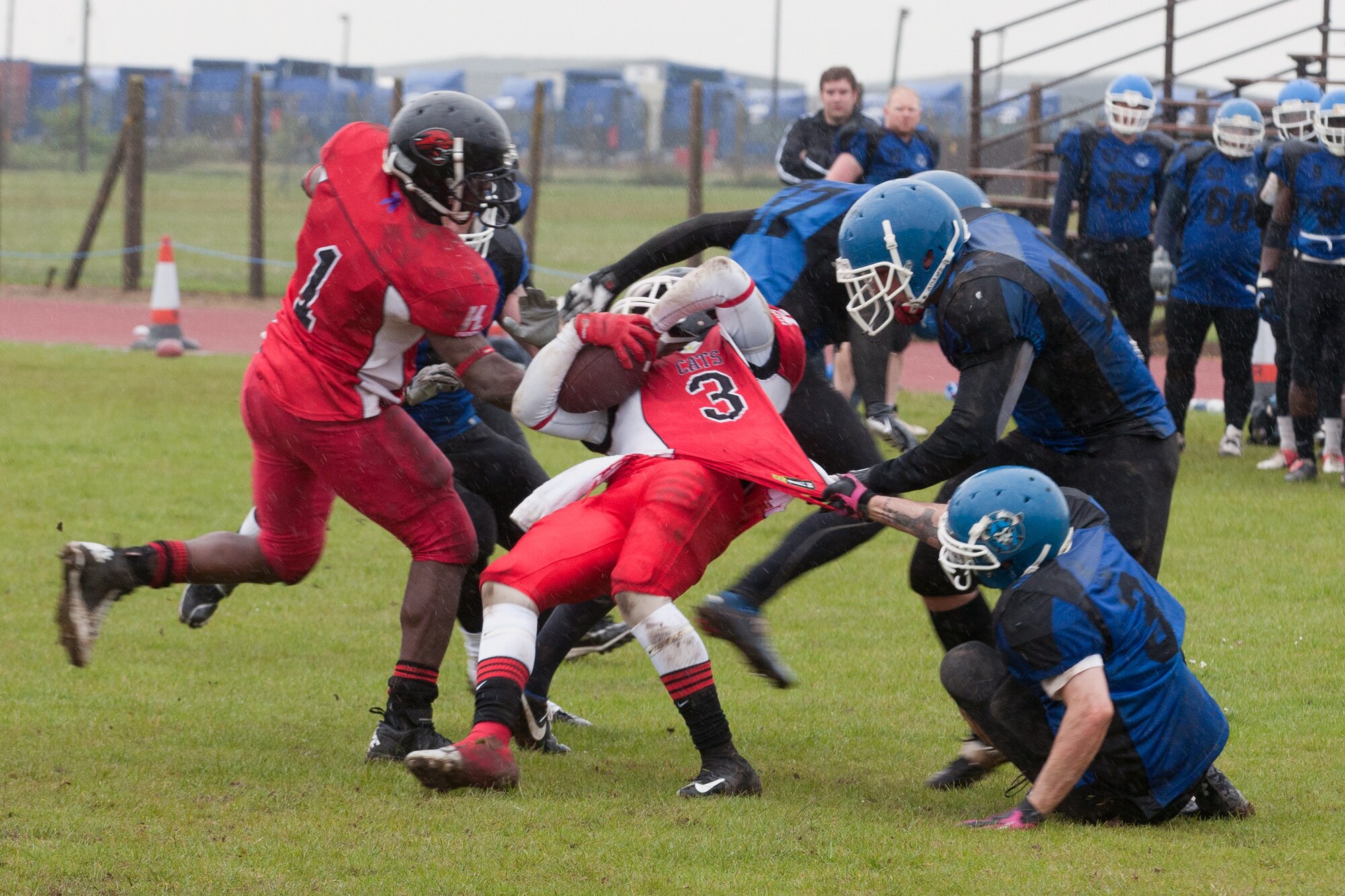 RAF ALCONBURY, United Kingdom – Albert Lamboy, Peterborough Saxons defensive back, holds onto the shirt of Martin Williams, Cambridgeshire Cats running back, during the second quarter of the first ever Bob "The Dog" Shaw Classic May 12 at the RAF Alconbury football field. These two teams have a history of playing each other for years and consider each other rivals. Both teams also have military personnel from RAF Alconbury, RAF Molesworth, RAF Mildenhall and RAF Lakenheath playing alongside British players. Coach Bob Shaw was a part of both teams as an offensive line coach for both the Saxons and Cats, and was the head coach for the Cats. (U.S. Air Force photo by Staff Sgt. Brian Stives)