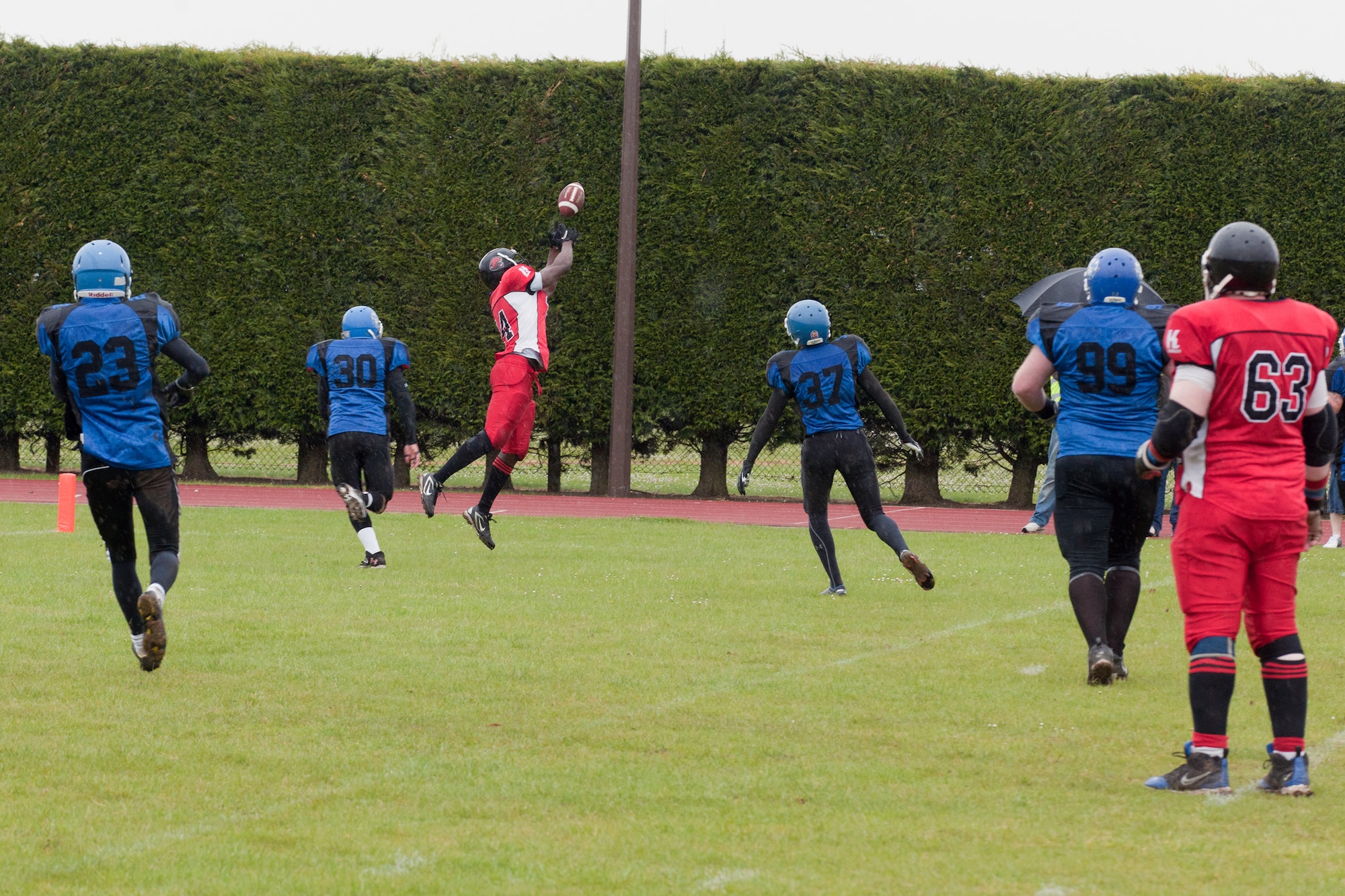 RAF ALCONBURY, United Kingdom – Samuel Anwti, Cambridgeshire Cats running back, makes a leaping catch in front of Alex Cushing , Peterborough Saxons defensive back, inside the five yard line during the second quarter of the first ever Bob "The Dog" Shaw Classic May 12 at the RAF Alconbury football field. These two teams have a history of playing each other for years and consider each other rivals. Both teams also have military personnel from RAF Alconbury, RAF Molesworth, RAF Mildenhall and RAF Lakenheath playing alongside British players. Coach Bob Shaw was a part of both teams as an offensive line coach for both the Saxons and Cats, and was the head coach for the Cats. (U.S. Air Force photo by Staff Sgt. Brian Stives)