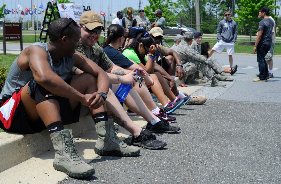 Participants of the 11th Security Forces Group, National Police Week Ruck March rest following the race on May 15, 2013 at Joint Base Andrews, Md. The 11th Security Forces Squadron hosted a barbeque and distributed awards for top finishing times. (U.S. Air Force photo/Airman 1st Class Nesha Humes)