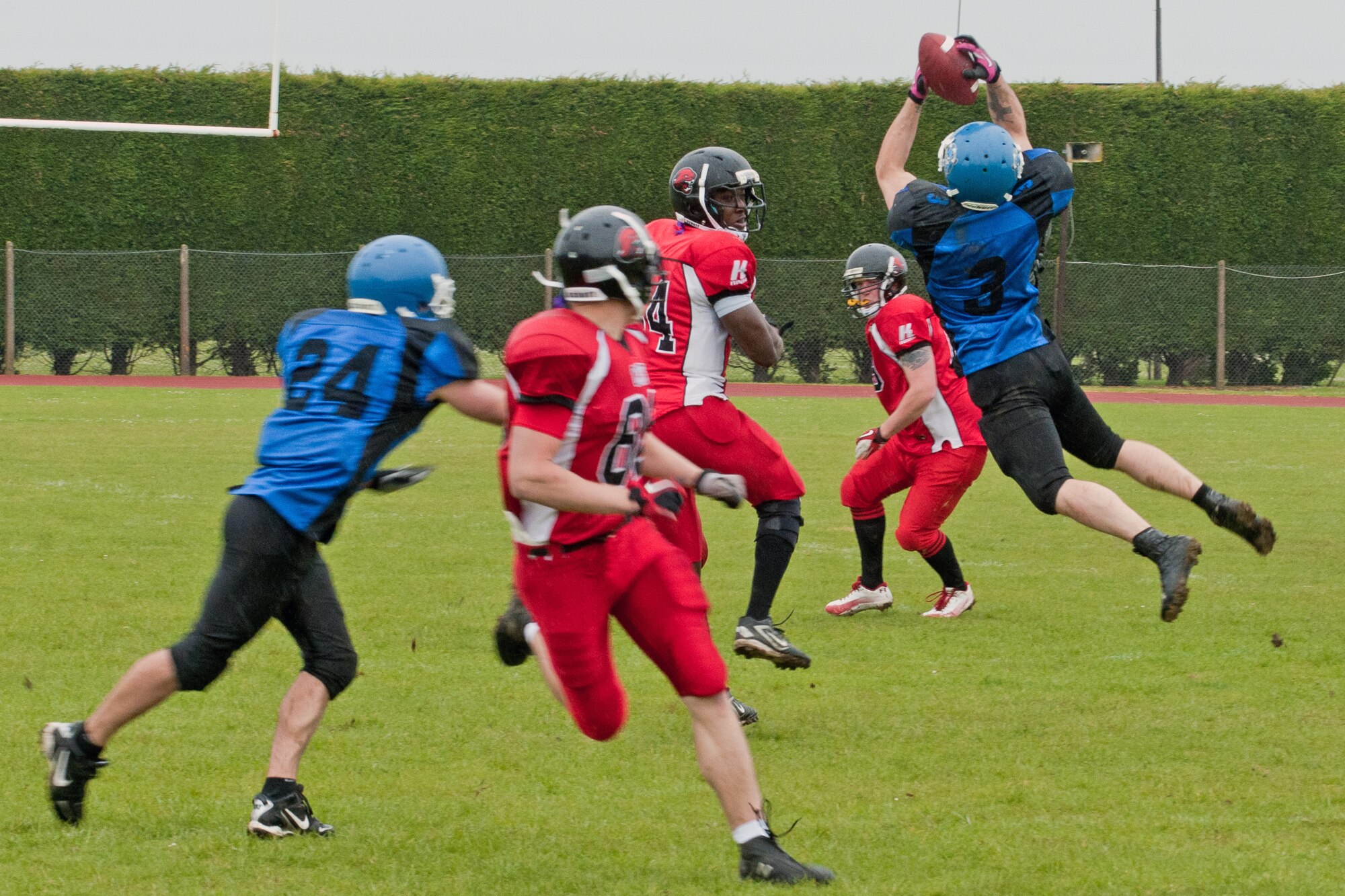 RAF ALCONBURY, United Kingdom – Albert Lamboy, Peterborough Saxons defensive back, intercepts a pass from Jonathan Randolph, Cambridgeshire Cats quarterback, during the first quarter of the first ever Bob "The Dog" Shaw Classic May 12 at the RAF Alconbury football field. These two teams have a history of playing each other for years and consider each other rivals. Both teams also have military personnel from RAF Alconbury, RAF Molesworth, RAF Mildenhall and RAF Lakenheath playing alongside British players. Coach Bob Shaw was a part of both teams as an offensive line coach for both the Saxons and Cats, and was the head coach for the Cats. (U.S. Air Force photo by Staff Sgt. Brian Stives)
