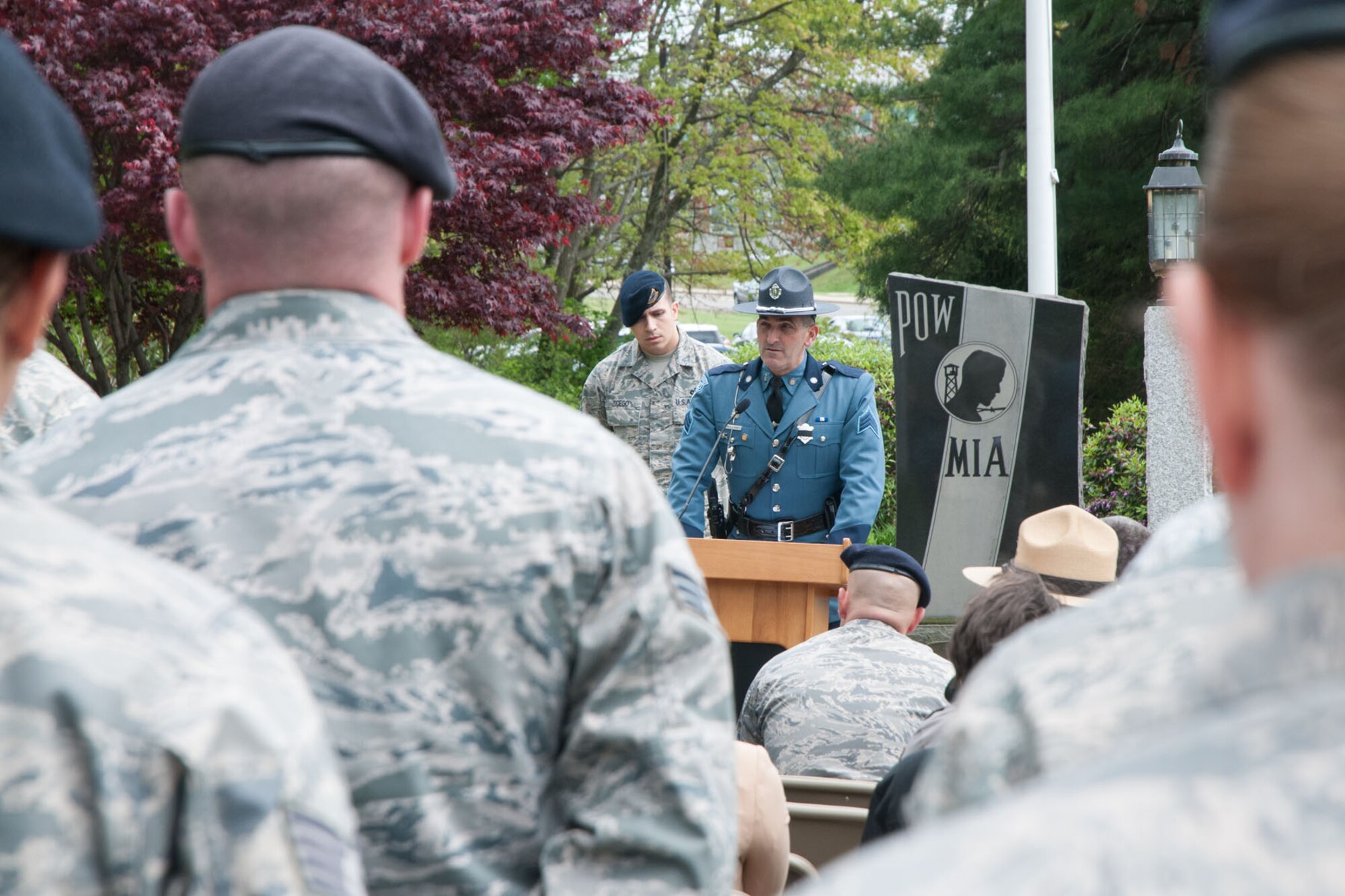 HANSCOM AIR FORCE BASE, Mass. – A flight of 66th Security Forces Squadron personnel stand and listen as Sgt. Steven Mullaney (standing in front), Massachusetts State Police director of training, addresses an audience during a POW/MIA retreat ceremony on the corner of Grenier and Barksdale Streets May 14. The event was held as a retreat ceremony and as a memorial ceremony for fallen police officers killed in the line of duty. (U.S. Air Force photo by Mark Herlihy)
