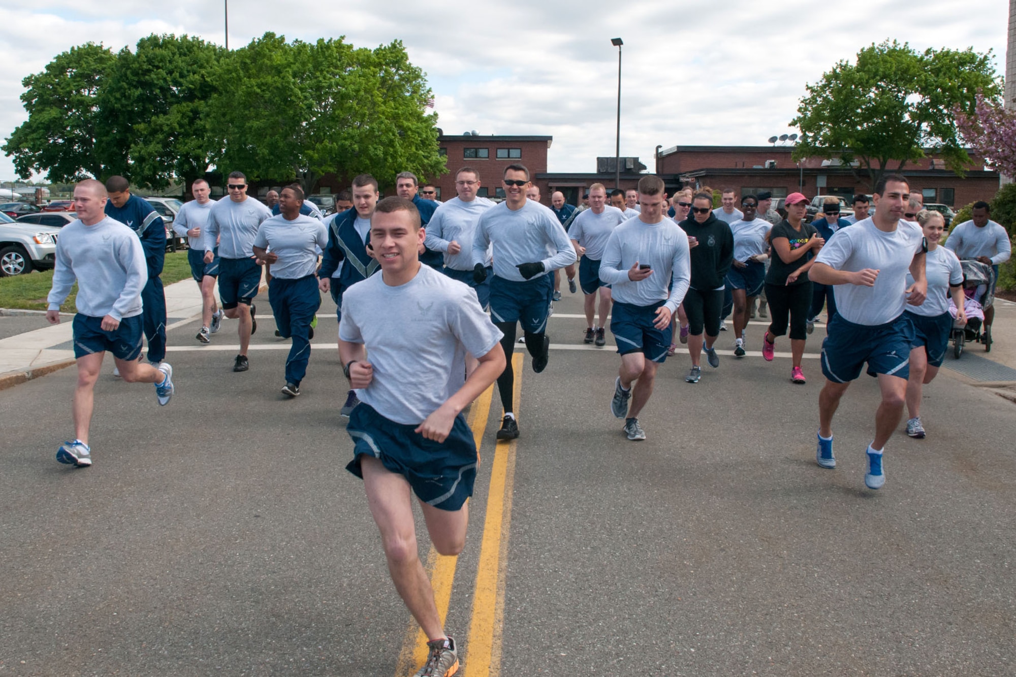 HANSCOM AIR FORCE BASE, Mass. -- Runners begin the Police Week 5K fun run outside the 66th Security Forces Squadron building May 13. The run followed the opening ceremony that kicked off Police Week. Airman 1st Class Shannon Taylor and 1st Lt. Courtney Swaney were the top male and female finishers respectively. (U.S. Air Force photo by Rick Berry)