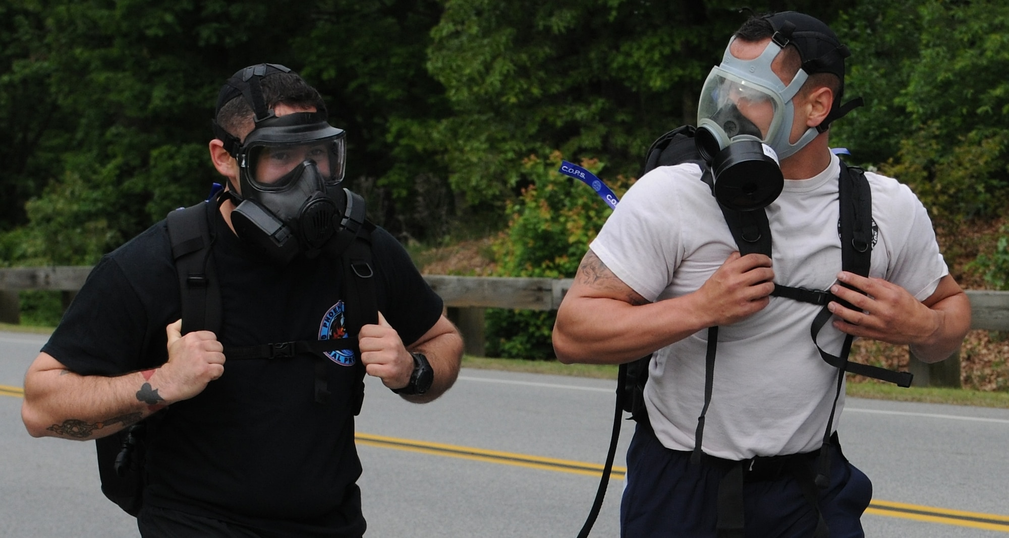 Staff Sergeants Kyle Martin and Jason Leavens, 811th Security Forces Squadron executive aircraft security members ran with gas masks during the 11th Security Forces Group National Police Week Ruck March on May 15, 2013 at Joint Base Andrews, Md. The gas masks can make it harder to breathe, due to reduced air flow through the filter. (U.S. Air Force photo/Airman 1st Class Nesha Humes)