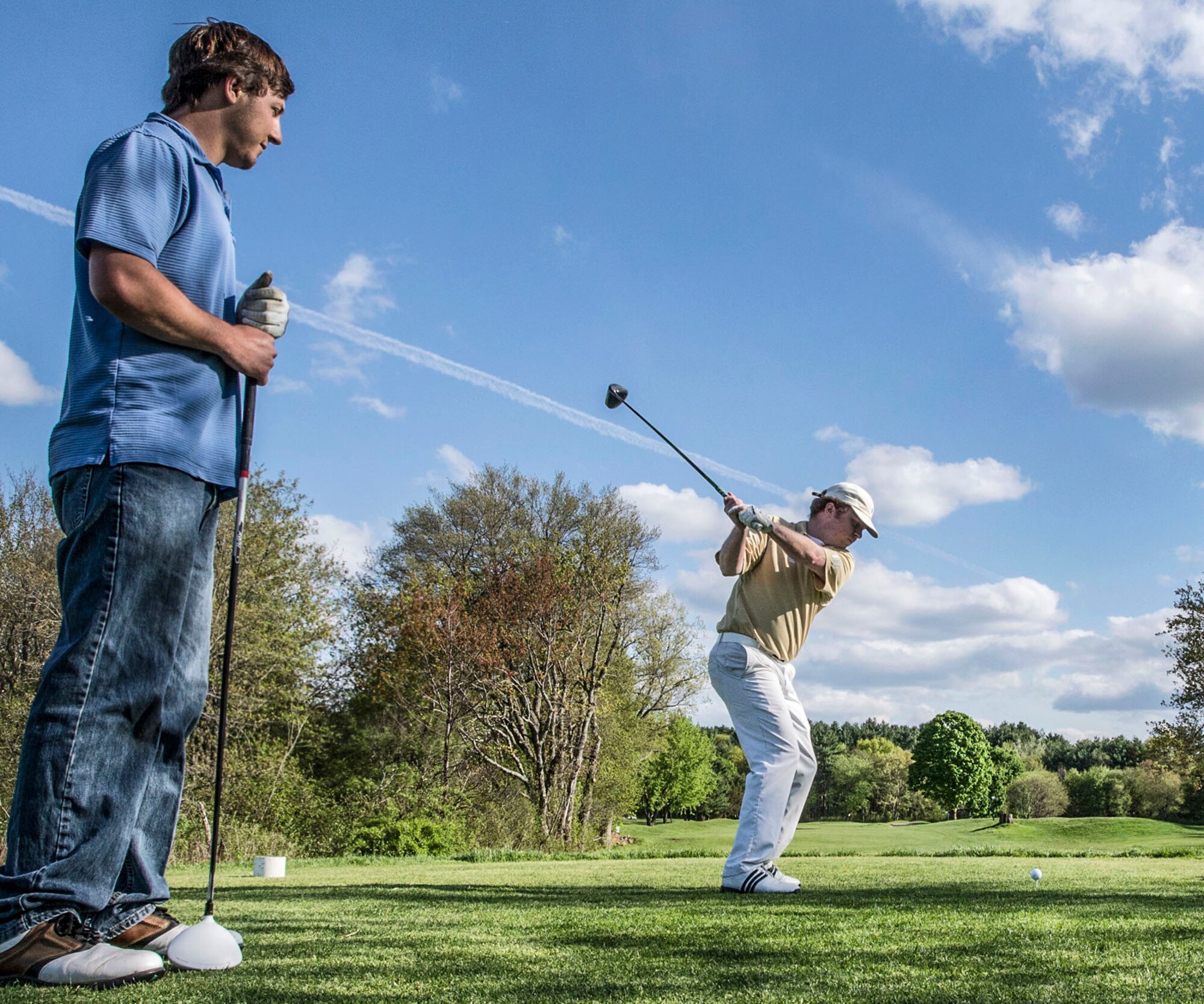 HANSCOM AIR FORCE BASE, Mass. - David Shepherd (right) shows his form as he drives a golf ball off the tee during a match with David LaMacchia at the Patriot Golf Course May 13. The Patriot Golf Course is located approximately four miles from Hanscom AFB on the grounds of the Veterans Administration Medical Center in Bedford and hosts several events throughout the season. For more information, visit www.hanscomservices.com/PatriotGolfCourse.asp. (U.S. Air Force photo by Walter Santos)