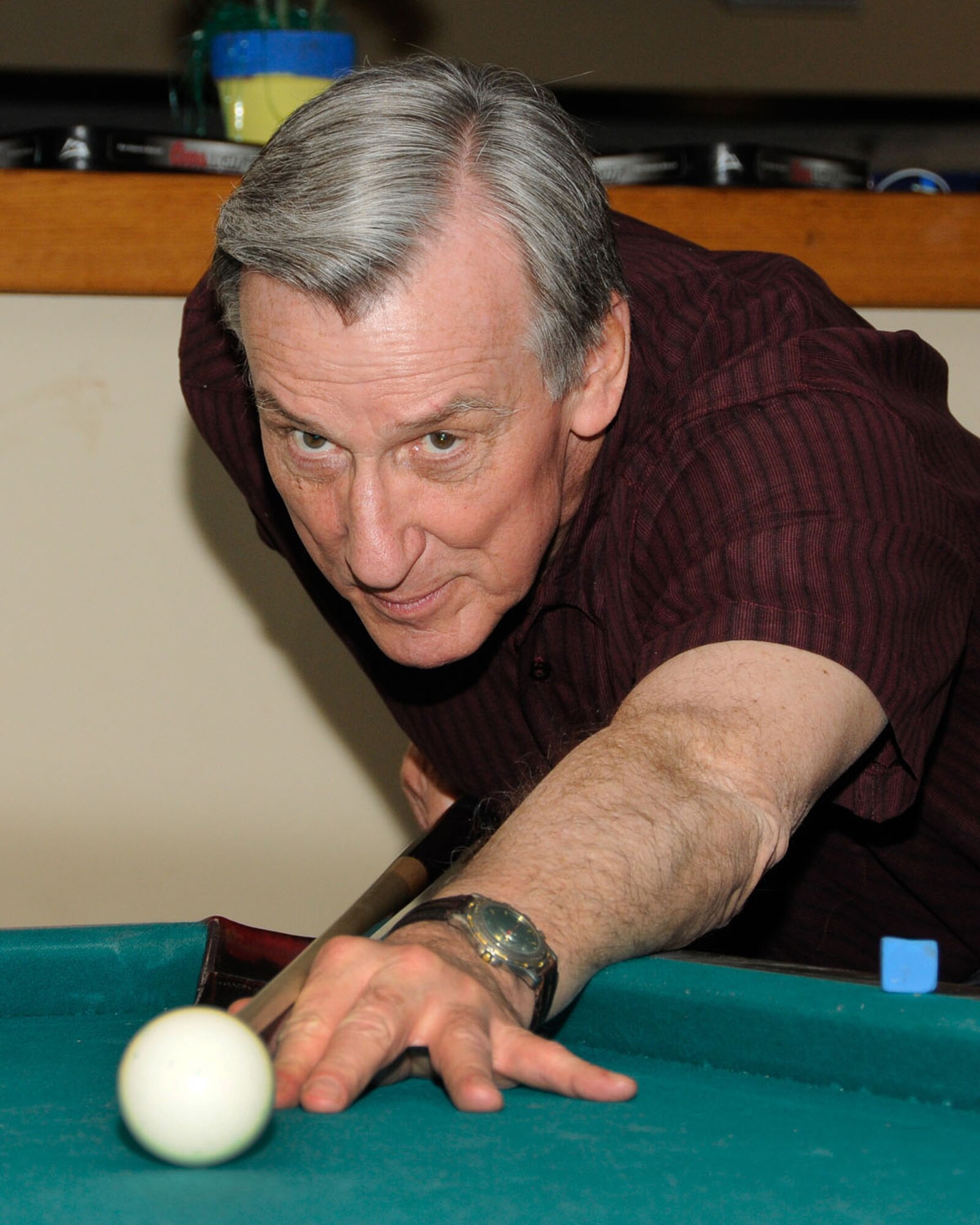 HANSCOM AIR FORCE BASE, Mass. -- Roland Petersen takes careful aim during an 8-Ball Round Robin Weekly Tournament at the Minuteman Commons May 6. Eleven league members participate in the tournament weekly during their lunch break. For more information on programs at the Minuteman Commons, contact 781-225-6501. (U.S. Air Force photo by Linda LaBonte Britt)