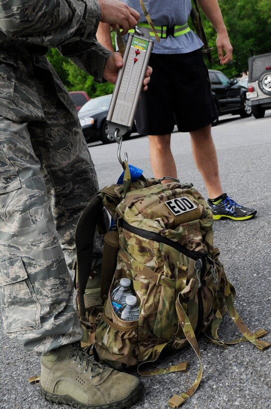 Master Sgt. John Franke, 11th Security Forces Group NCOIC resource advisor weighs back packs for the 11th SFG, National Police Week Ruck March on May 15, 2013 at Joint Base Andrews, Md.  Participants filled their back packs with sand, weights and medicine balls to meet the 35 pound minimum requirement. (U.S. Air Force photo/Airman 1st Class Nesha Humes)
