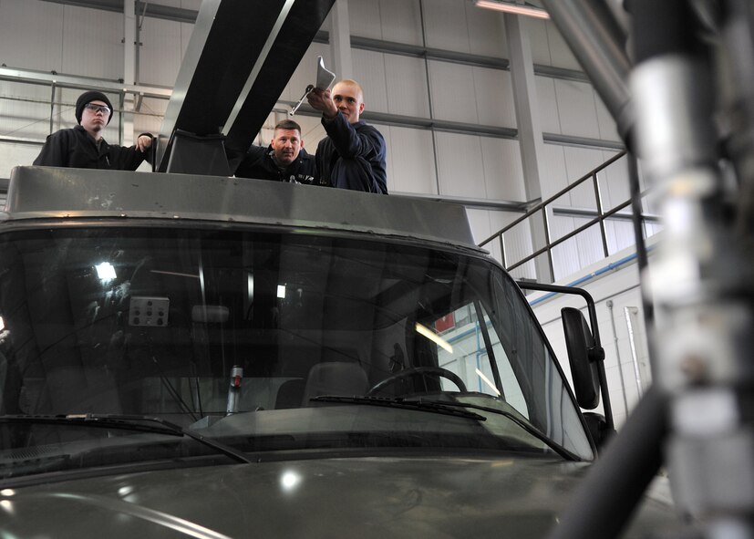 From left, Airman 1st Class Jacob Ward, 100th Logistics Readiness Squadron vehicle and vehicular equipment mechanic from Roseburg, Ore., Chief Master Sgt. Tracy Jones, 100th Air Refueling Wing command chief and Senior Airman Kane Goligoski, 100th LRS vehicle and vehicular equipment mechanic from Columbus, Ga., inspect a global deicer’s boom slide pad May 15, 2013, on RAF Mildenhall, England. Seasonal inspections of the global deicer are critical to allow sufficient time for necessary inspections, repairs and replacements before the winter season. (U.S. Air Force photo by Senior Airman Jerilyn Quintanilla/Released) 