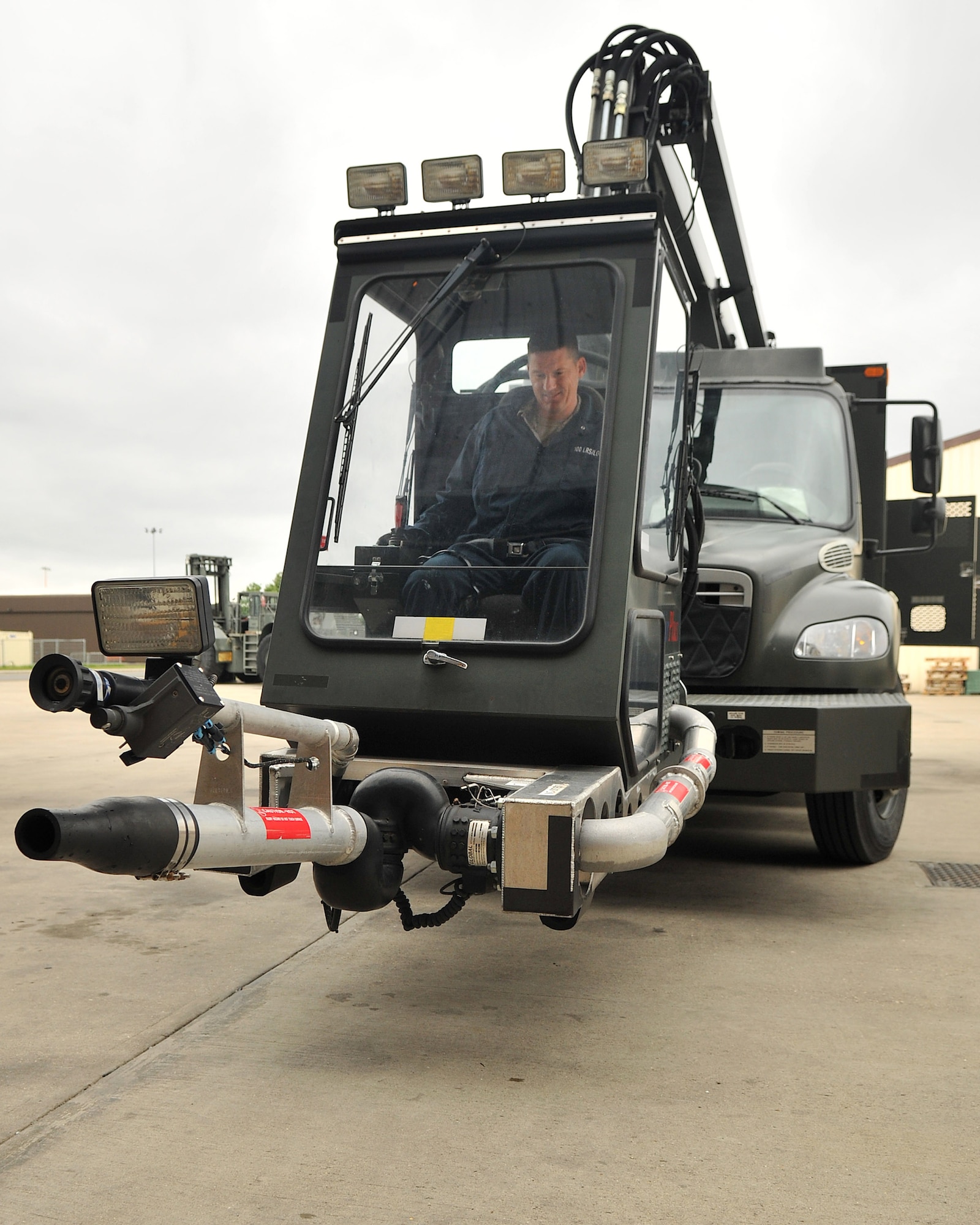 Chief Master Sgt. Tracy Jones, 100th Air Refueling Wing command chief, performs an operations check aboard a global deicer’s Fluid Efficiency Dispensing System cab during a visit to the 100th Logistics Readiness Squadron Special Purpose shop May 15, 2013, on RAF Mildenhall, England. The shop performs regular inspections of the global deicer during the summer to prepare for the winter season. (U.S. Air Force photo by Senior Airman Jerilyn Quintanilla/Released)