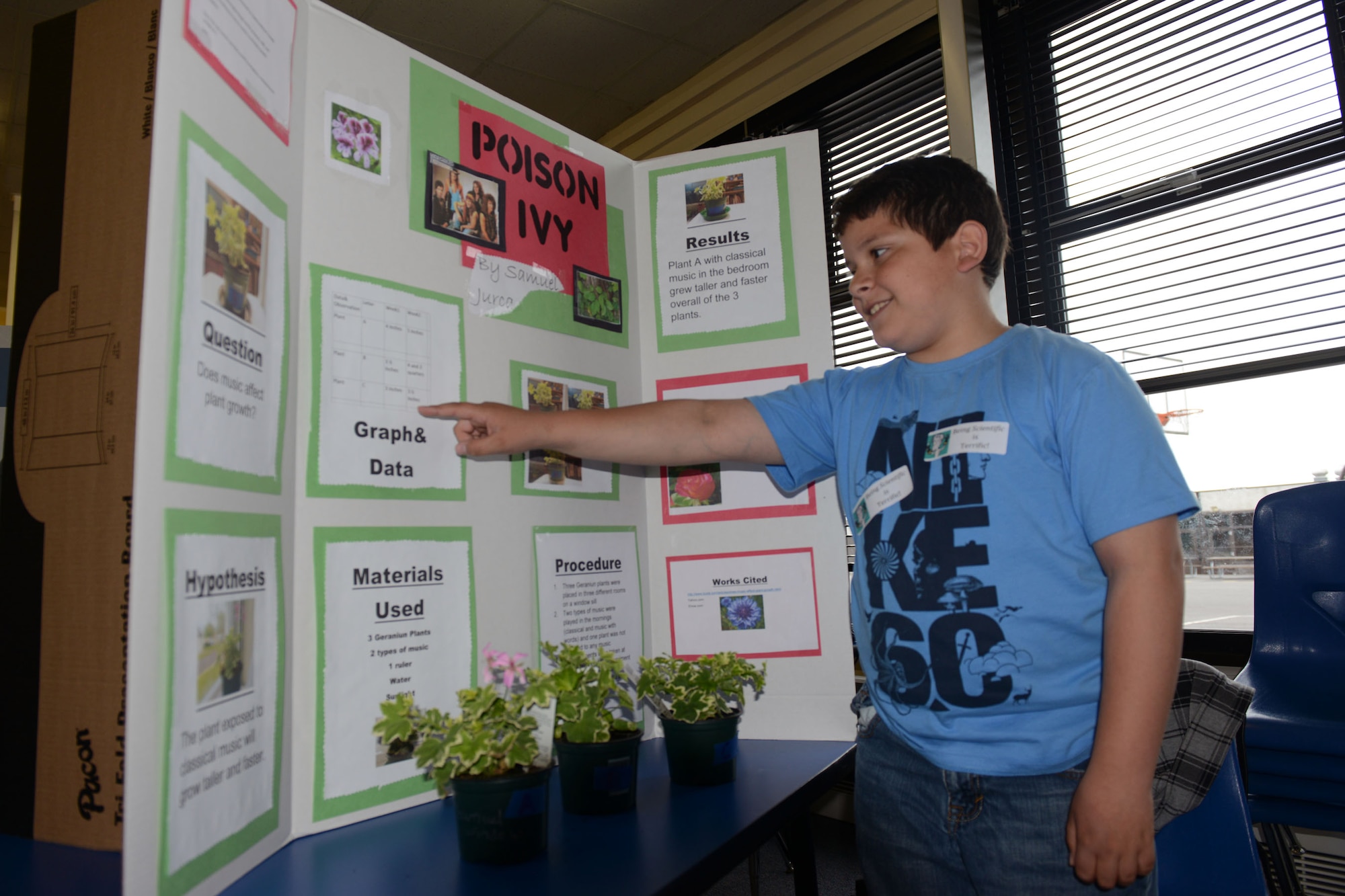 RAF ALCONBURY, United Kingdom – Samuel Jurca talks about his experiment with how music affects plant growth during the Alconbury ES Science Fair at the Alconbury Elementary School May 15. The theme was “The Scientific Process” and answered questions such as Can worms survive in different environments? Will plants grow when fed Dr. Pepper? Does a girl have a better memory than a boy does? Entries included Individual student projects, class projects and family projects. (U.S. Air Force photo by Tech. Sgt. Chrissy Best)