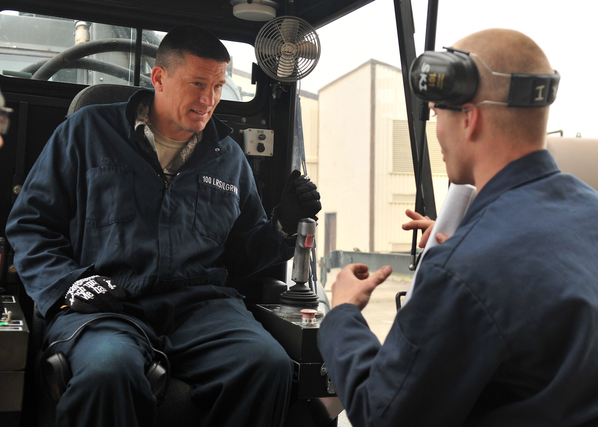 From right, Senior Airman Kane Goligoski, 100th Logistics Readiness Squadron vehicle and vehicular equipment mechanic from Columbus, Ga., briefs Chief Master Sgt. Tracy Jones, 100th Air Refueling Wing command chief, on basic operations checks procedures for a global deicer May 15, 2013, on RAF Mildenhall, England. Jones assisted Airmen with the inspection of the vehicle as part of the base’s “dirty jobs” program. (U.S. Air Force photo by Senior Airman Jerilyn Quintanilla/Released)