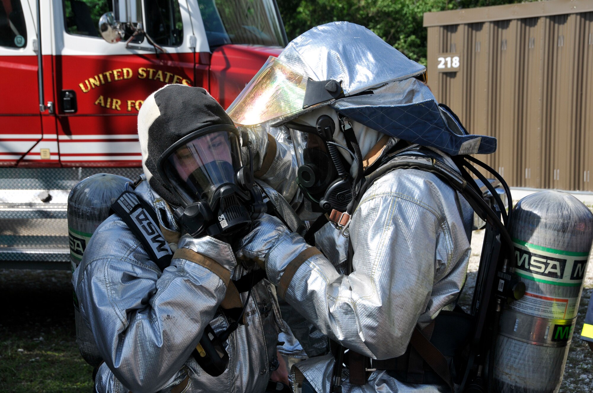Members of Homestead Air Reserve Base, Fla.’s Fire Department adjust each other’s fire proximity suits, also known as bunker suits, prior to aircraft live fire training at Homestead ARB May 15. The aircraft live fire training consists of responding to the fire, setting up on the aircraft, deploying hose lines, and attacking and extinguishing the fire. (U.S. Air Force photo/Senior Airman Nicholas Caceres)