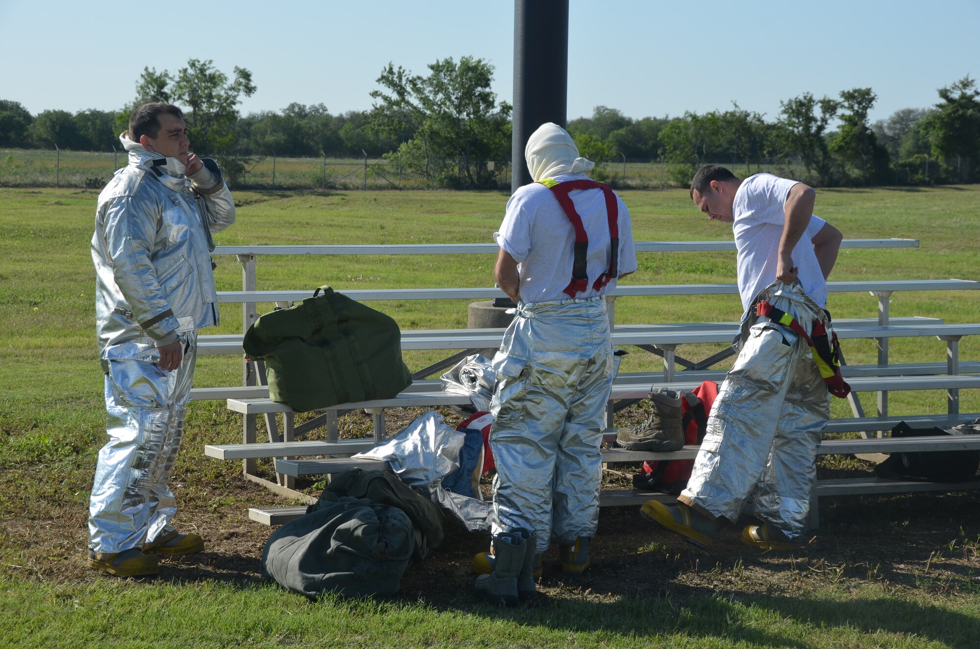 Members of the 433rd Civil Engineer Squadron, Fire and Emergency service, don fire suits before live fire training May 3 at Joint Base San Antonio-Randolph, Texas. (U.S. Air Force photo by Minnie Jones)