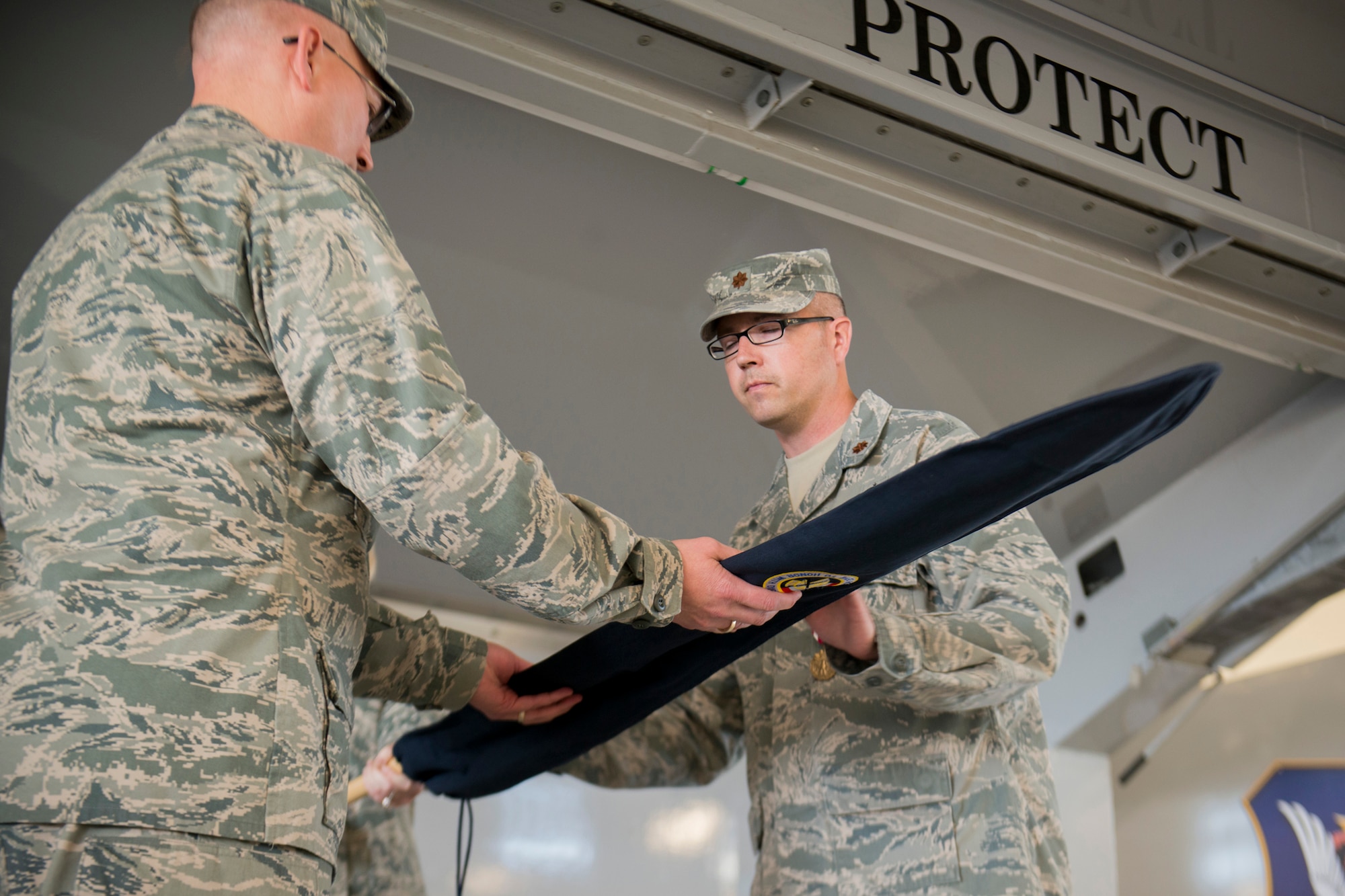 U.S. Air Force Col. Jeffrey Decker, 23d Maintenance Group commander (left), and Maj. Aaron Buck, 23d Maintenance Operations Squadron commander, case the 23d MOS guidon during an inactivation ceremony May 15, 2013, at Moody Air Force Base, Ga. Moody activated the 23d MOS on Oct. 1, 2006. (U.S. Air Force photo by Staff Sgt. Jamal D. Sutter/Released)
