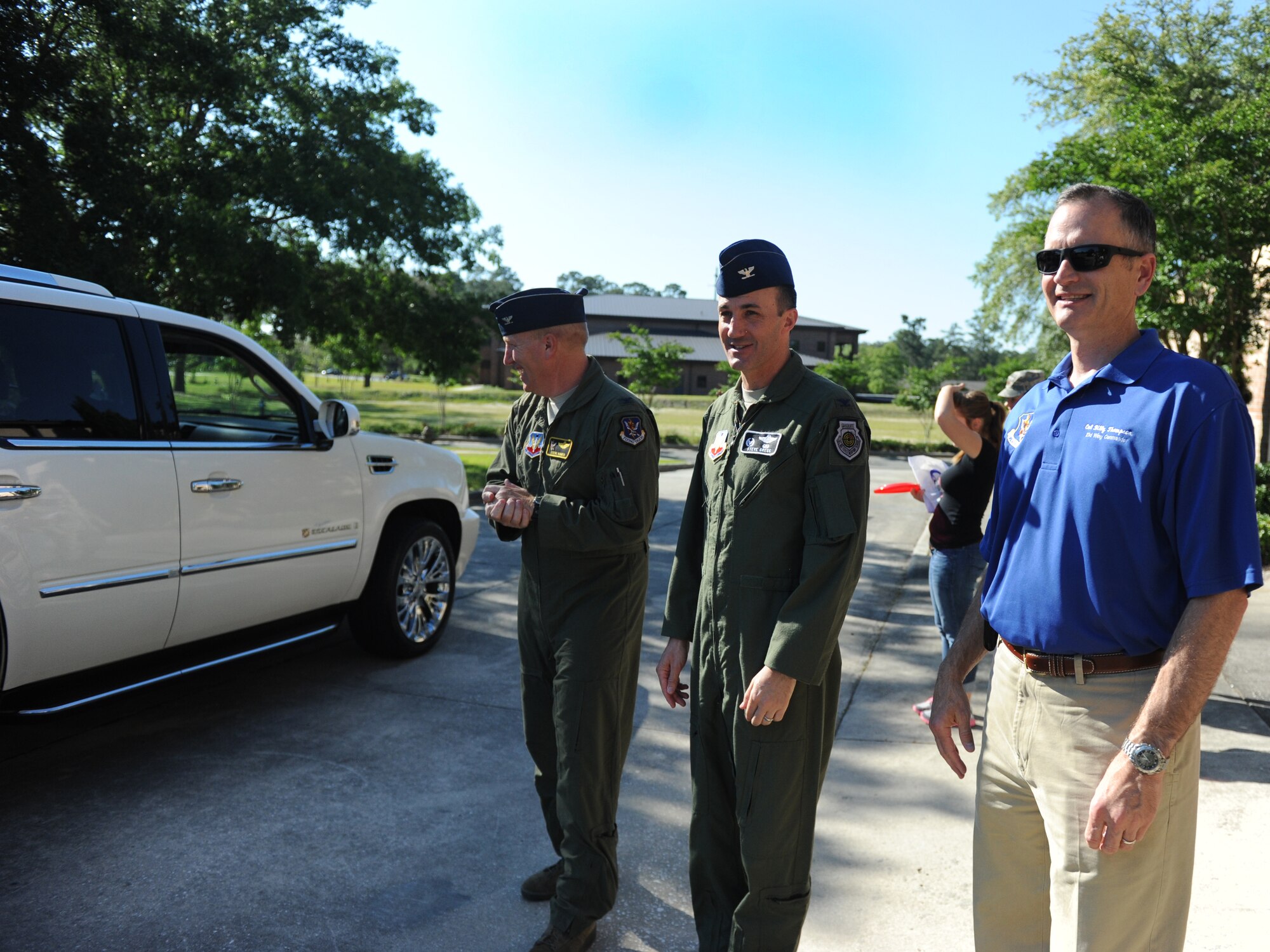 U.S. Air Force Col. Steven Ramer, 23d Wing vice commander (left), Col. Steven Gregg, 347th Rescue Group commander (center), and Col. Billy Thompson, 23d Wing commander, offer support during the Drive-Thru Spouse Deployed Dinner May 14, 2013, at Moody Air Force Base, Ga. Spouses of deployed Airmen were able to go to the drive-thru and pick up prepared meals.  ( U.S. Air Force photo by Staff Sgt. Melissa K. Mekpongsatorn/Released)
