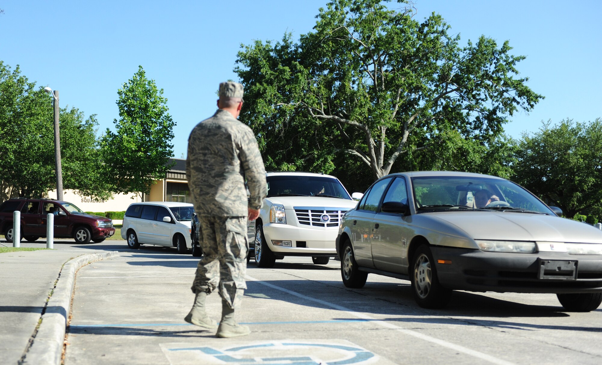 Cars line up in front of the chapel May 14, 2013, at Moody Air Force Base, Ga., as spouses of deployed Airmen wait to pick up prepared meals during the Drive-Thru Spouse Deployed Dinner. Volunteers from across the base came together to put together and hand out more than 200 meals for the families of deployed Moody Airmen. ( U.S. Air Force photo by Staff Sgt. Melissa K. Mekpongsatorn/Released)
