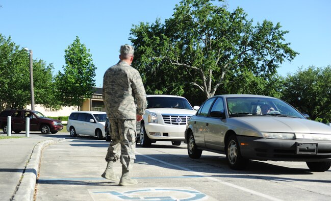 Cars line up in front of the chapel May 14, 2013, at Moody Air Force Base, Ga., as spouses of deployed Airmen wait to pick up prepared meals during the Drive-Thru Spouse Deployed Dinner. Volunteers from across the base came together to put together and hand out more than 200 meals for the families of deployed Moody Airmen. ( U.S. Air Force photo by Staff Sgt. Melissa K. Mekpongsatorn/Released)
