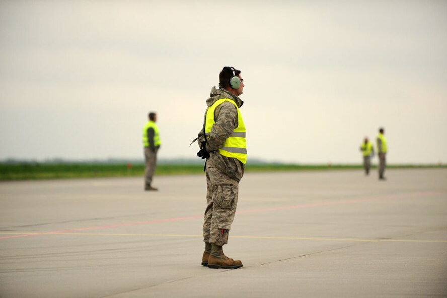 Tech. Sgt. David Bizefski awaits the launch of a U.S. Air Force F-16 Fighting Falcon fighter aircraft during the first mission of Aviation Detachment Rotation 13-2, a joint theater security cooperation event. U.S. and Polish air force F-16s, along with MiG-29s and Su-22s will conduct simulated air combat scenarios with both nations' forces working toward a common objective. (U.S. Air Force photo/Tech. Sgt. Kenya Shiloh)