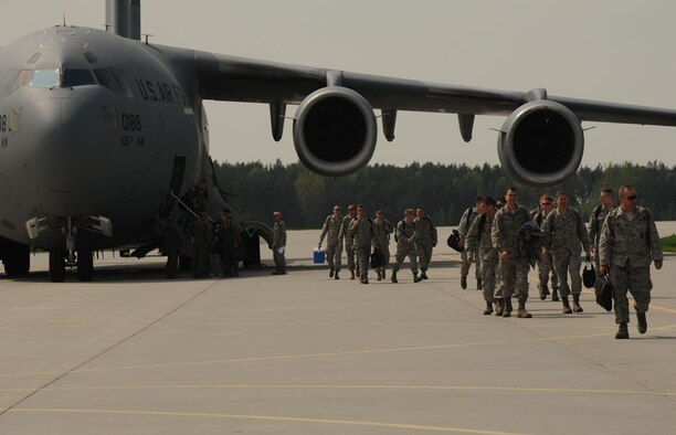 LASK AIR BASE, Poland - Members of the 115th Fighter Wing, Wisconsin Air National Guard, arrive at Lask Air Base, Poland, for Aviation Detachment Rotation 13-2, May 9, 2013. More than 100 Airmen will be working with the Polish Air Force for the first F-16 fighter aircraft rotation and second overall this year. The first rotation took place at Powidz Air Base with the C-130J Super Hercules from the 37th Airlift Squadron, Ramstein Air Base, Germany.(U.S. Air Force photo by Tech. Sgt. Kenya Shiloh/released)