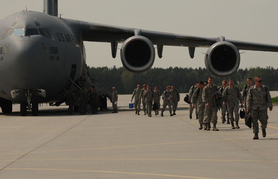 Members of the 115th Fighter Wing, Wisconsin Air National Guard, arrive at Lask Air Base, Poland, for Aviation Detachment Rotation 13-2, May 9, 2013. More than 100 Airmen will be working with the Polish air force for the first F-16 fighter aircraft rotation and second overall this year. The first rotation took place at Powidz Air Base with the C-130J Super Hercules from the 37th Airlift Squadron, Ramstein AB, Germany.(U.S. Air Force photo/Tech. Sgt. Kenya Shiloh)