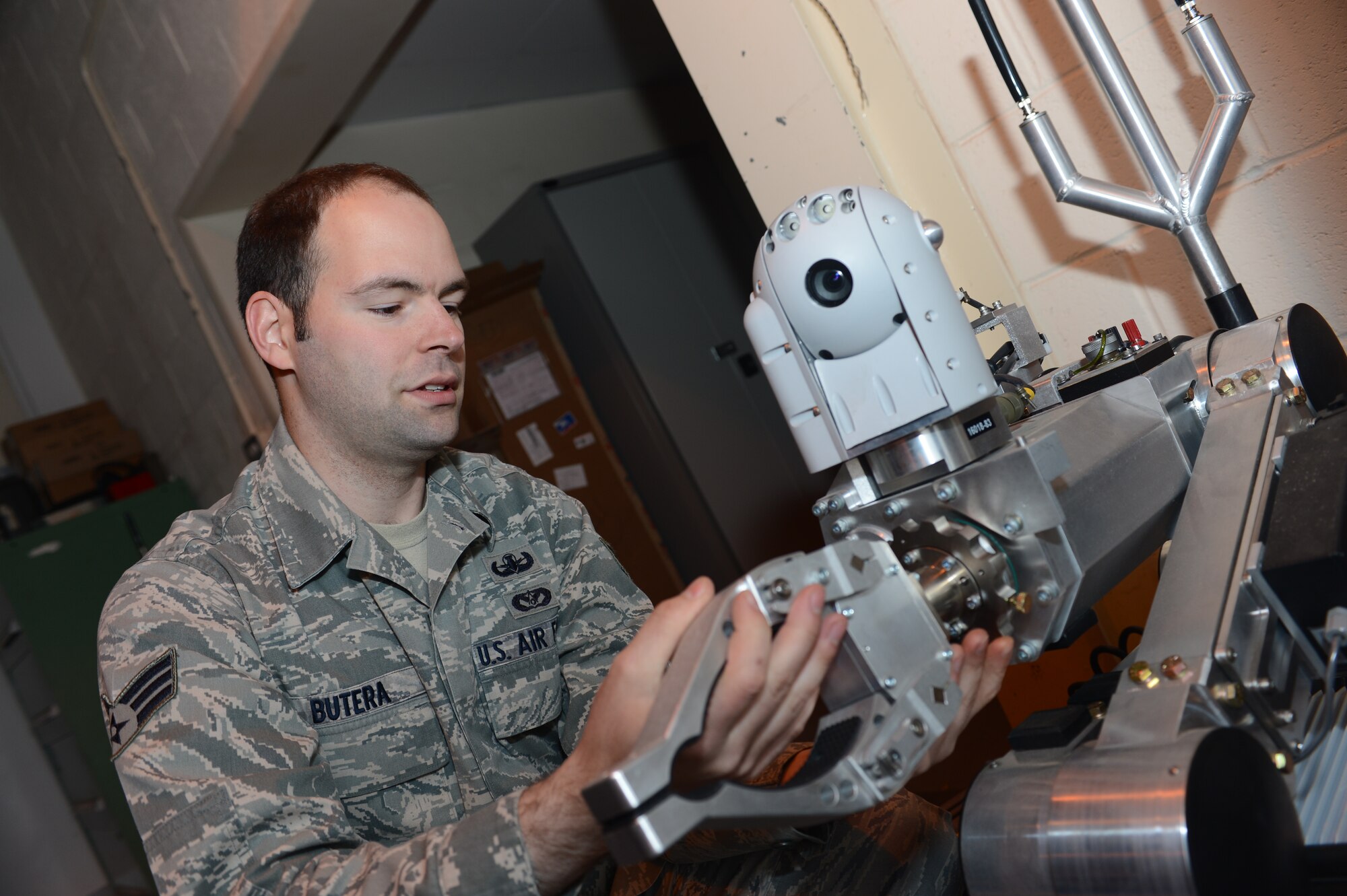 ROYAL AIR FORCE LAKENHEATH, England – Senior Airman Jeffrey Butera, 48th Civil Engineer Squadron explosive ordnance disposal technician, inspects an Air Force medium sized robot May 15, 2013. Butera was nominated for a Liberty Spotlight because he displays the core value of “Excellence in All We Do” (U.S. Air Force photo by Airman1st Class Dana J. Butler) 
