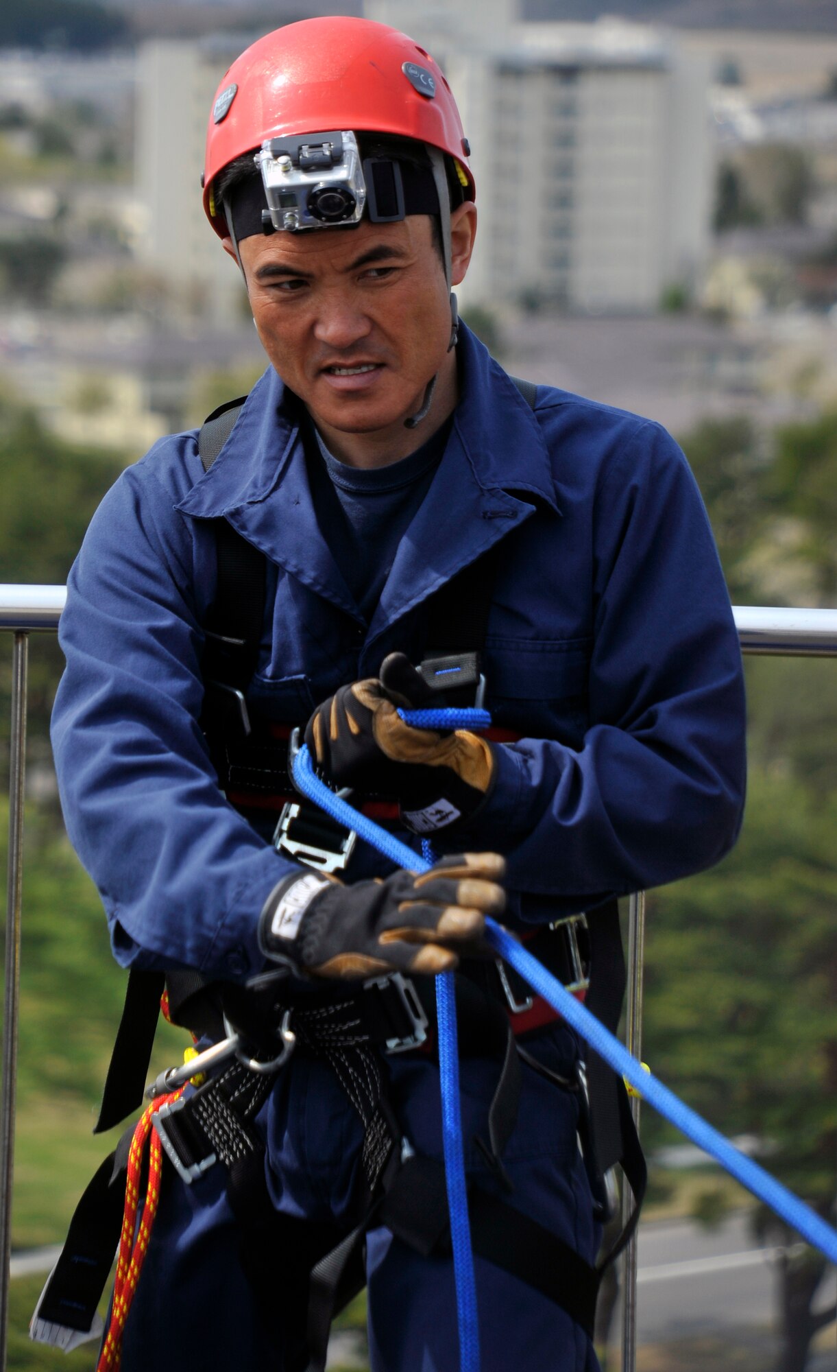 Tadakatsu Kumagai, 35th Civil Engineer Squadron firefighter, works the main rope line during warrior day rappel training at Misawa Air Base, Japan, May 10, 2013. Airmen of the 35 CES fire department trained with their Japanese counterparts to sharpen their emergency rescue skills. (U.S. Air Force photo by Airman 1st Class Zachary Kee)