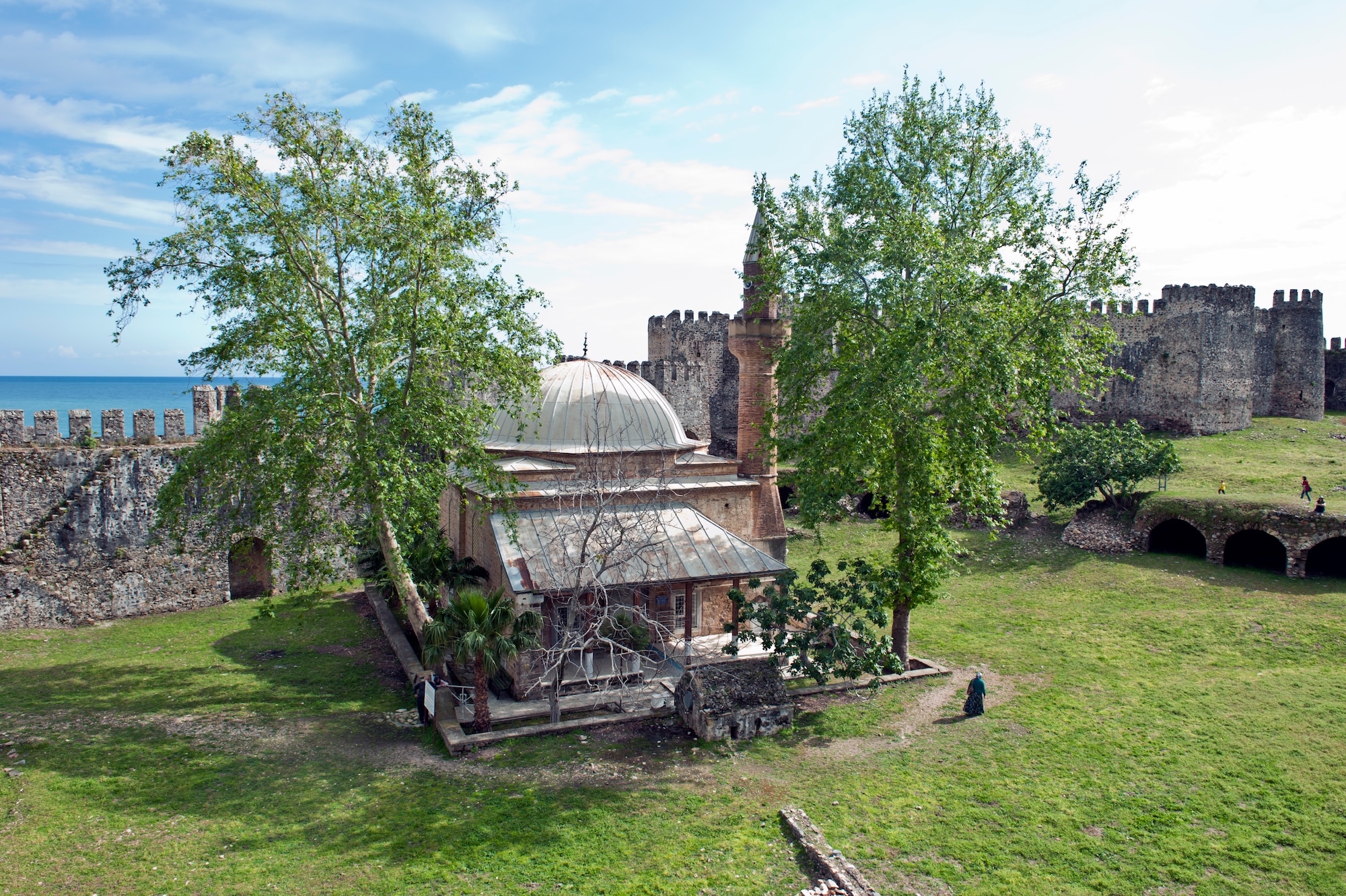 A Turkish woman walks by the mosque nestled within Mamure Castle April 20, 2013, at Anamur, Turkey. Approximately 130 miles west of Mersin, Mamure was designed to fend off seafaring pirates. (U.S. Air Force photo by Senior Airman Daniel Phelps/Released)