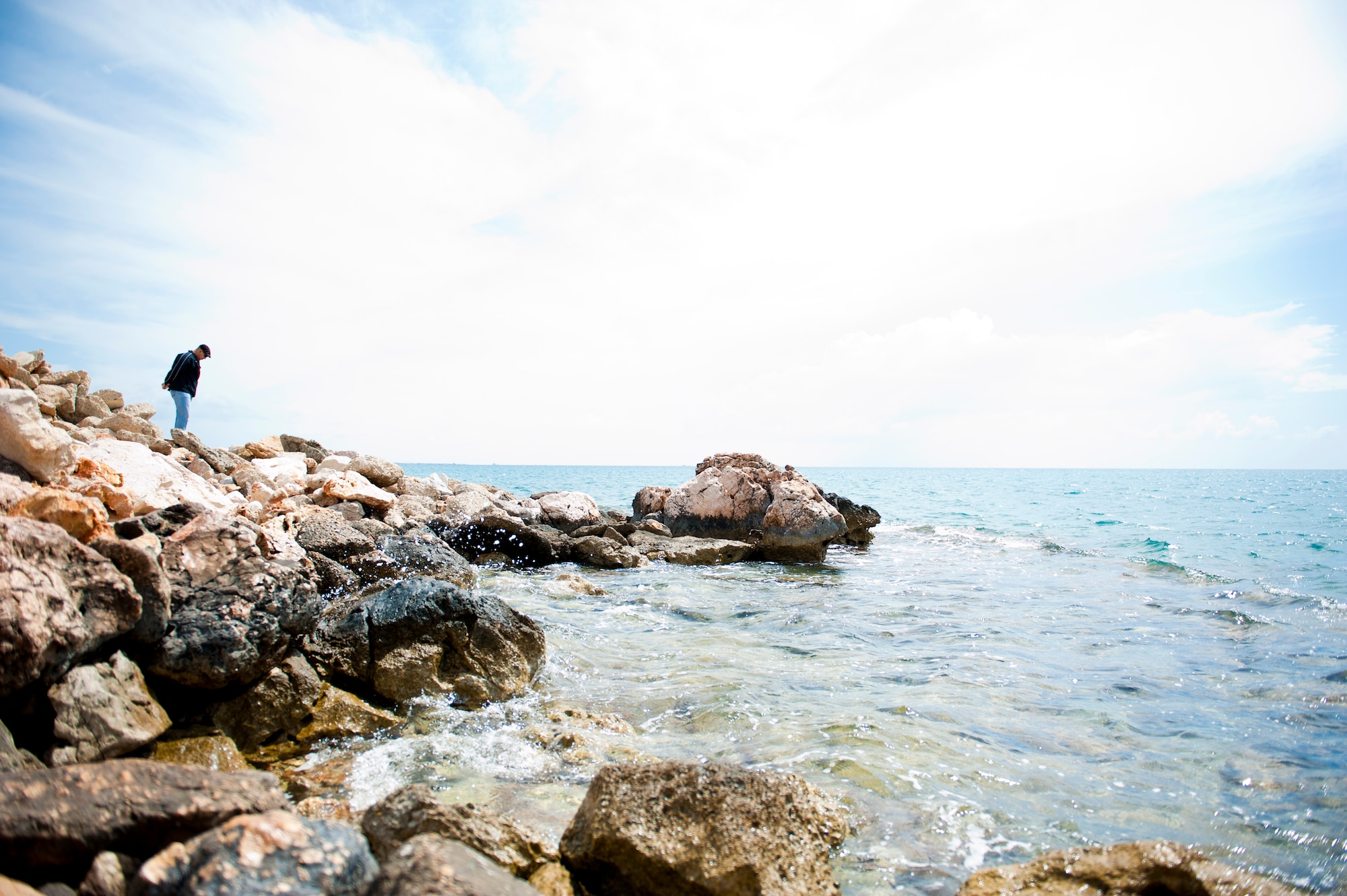 A visitor to the Mediterranean coast walks along the rocks to get a closer look at the water April 20, 2013, in the Mersin Province, Turkey. The Mediterranean coast of Turkey is mostly a narrow strip of land in between the Taurus Mountains and the Sea. (U.S. Air Force photo by Senior Airman Daniel Phelps/Released)