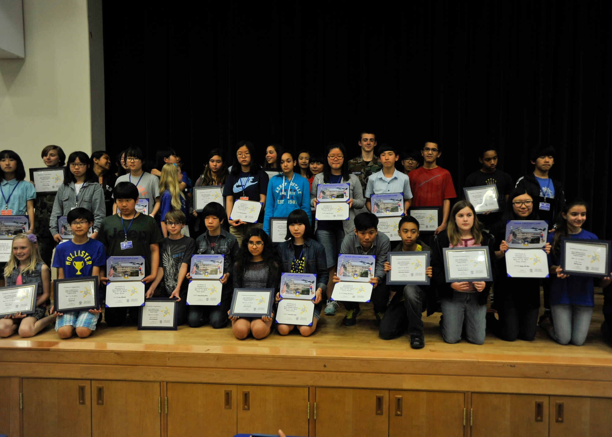 Participants of the Osan Middle School English Camp gather for a photo in the school cafeteria at Osan Air Base, Republic of Korea, May 15, 2013. The camp, which ran May 13-15, gave both Korean and American students a chance to get a taste of each other’s culture and an opportunity to practice their language and communication skills. Throughout the three-day camp, the Korean students shadowed their American counterparts at school before spending the night with their host families. (U.S. Air Force photo/Senior Airman Siuta B. Ika)