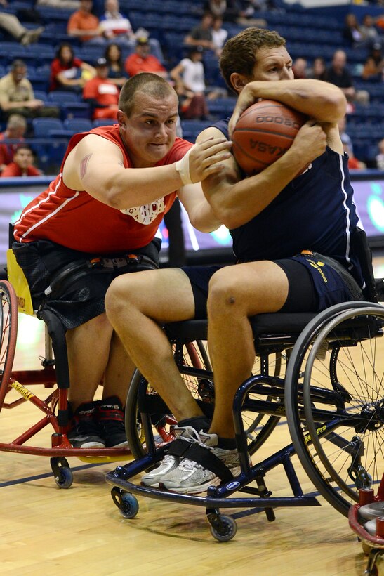 Marine Corps Lance Cpl. Zach Blair, left, attempts a steal from retired Navy Petty Officer 2nd Class Joseph Frank during the bronze medal wheelchair basketball game at the 2013 Warrior Games in Colorado Springs, Colo., May 15, 2013. 