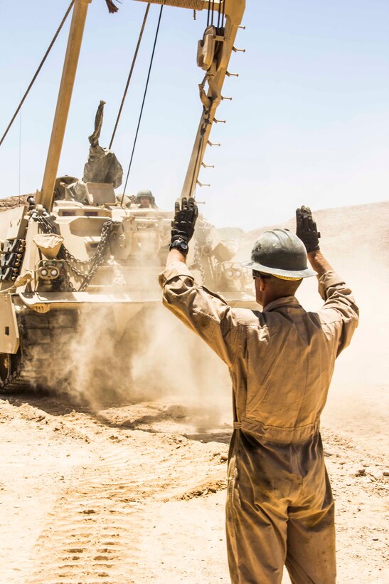 Gunnery Sgt. Jonathan Griffith, ordnance and maintenance chief from Idaho Falls, Idaho, assigned to Combat Logistics Battalion 26, 26th Marine Expeditionary Unit (MEU), guides the M-88A2 heavy recovery vehicle forward to assist in lifting an amphibious assault vehicle engine during an exercise in the 5th Fleet area of responsibility April 28, 2013. The 26th MEU is currently deployed as part of the Kearsarge Amphibious Ready Group to the 5th Fleet area of responsibility. The 26th MEU operates continuously across the globe, providing the president and unified combatant commanders with a forward-deployed, sea-based quick reaction force. The MEU is a Marine Air-Ground Task Force capable of conducting amphibious operations, crisis response, and limited contingency operations.
(U.S. Marine Corps photo by Cpl. Michael S. Lockett/Released)
