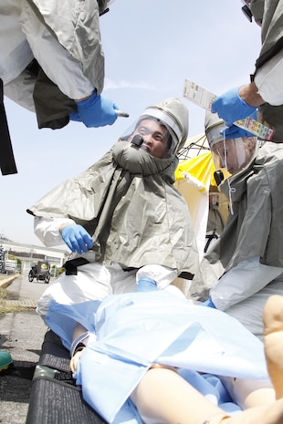 Sailors from Robert M. Casey Medical and Dental Clinic conduct triage on a victim during a practical exercise in First Receiver Operations Training hosted by the Decontamination Education and Consulting on Nuc/Bio/Chem (DECON) near Penny Lake Field at Marine Corps Air Station Iwakuni, Japan, May 9, 2013