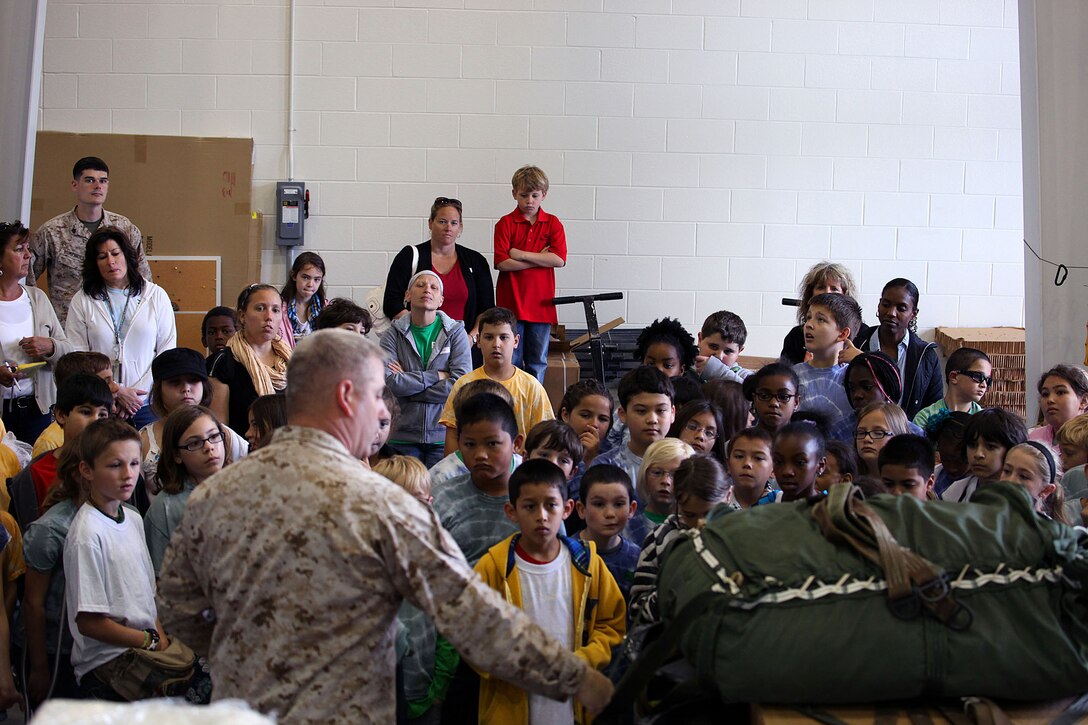 Approximately five classes totaling 120 students from the 4th Grade class from Bitz Intermediate School visited the U.S. Marine Corps Forces, Special Operations Command Paraloft. "It’s good for them, we put things into perspective for the kids and they learn how parachutes work," said Sgt. Patrick Ward, 27, Marine Special Operations Regiment, parachute rigger, from Rockford, Mich. The Marines displayed the numerous types of equipment and the different parachutes they use. 