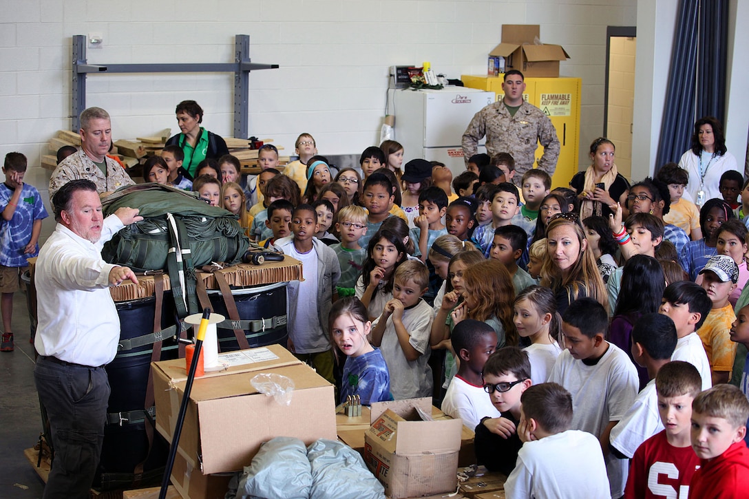 Approximately five classes totaling 120 students from the 4th Grade class from Bitz Intermediate School visited the U.S. Marine Corps Forces, Special Operations Command Paraloft. "It’s good for them, we put things into perspective for the kids and they learn how parachutes work," said Sgt. Patrick Ward, 27, Marine Special Operations Regiment, parachute rigger, from Rockford, Mich. The Marines displayed the numerous types of equipment and the different parachutes they use. 