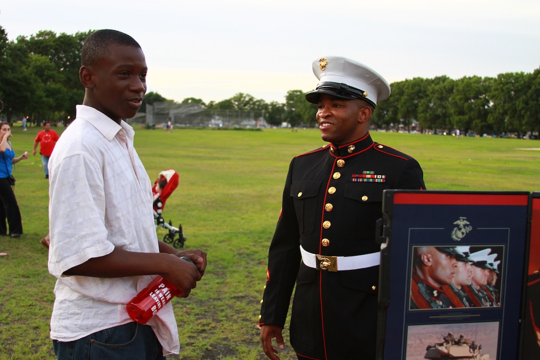 Sgt. James Kinard, a recruiter with Marine Corps Recruiting Substation Flatbush, talks to a young man during the National Night Out Against Crime at Marine Park in Brooklyn, N.Y., Aug. 7, 2012. The New York Police Department organized numerous different events throughout the boroughs that same night to heighten awareness of crime and how to prevent it.