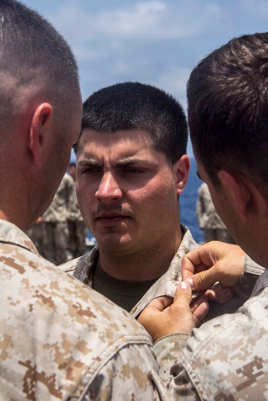 Marines pin Cpl. Steven Fernandez, squad leader from Waterburg, Conn., with Company K, Battalion Landing Team 3/2, 26th Marine Expeditionary Unit (MEU), during his promotion aboard the USS Carter Hall (LSD 50) while at sea May 5, 2013. The 26th MEU is currently deployed as part of the Kearsarge Amphibious Ready Group to the 5th Fleet area of responsibility. The 26th MEU operates continuously across the globe, providing the president and unified combatant commanders with a forward-deployed, sea-based quick reaction force. The MEU is a Marine Air-Ground Task Force capable of conducting amphibious operations, crisis response, and limited contingency operations.
(U.S. Marine Corps photo by Cpl. Michael S. Lockett/Released)