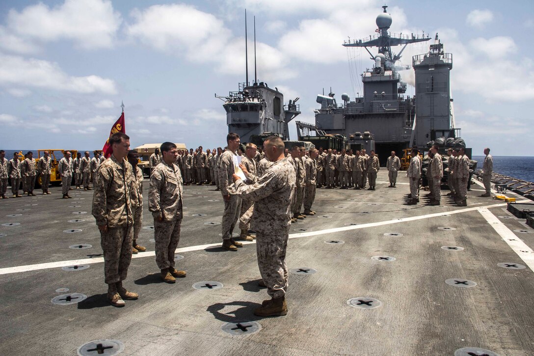 Capt. Raymond Kaster, Company K commanding officer, Battalion Landing Team 3/2, 26th Marine Expeditionary Unit (MEU), promotes Marines of Company K aboard the USS Carter Hall (LSD 50) while at sea May 5, 2013. The 26th MEU is currently deployed as part of the Kearsarge Amphibious Ready Group to the 5th Fleet area of responsibility. The 26th MEU operates continuously across the globe, providing the president and unified combatant commanders with a forward-deployed, sea-based quick reaction force. The MEU is a Marine Air-Ground Task Force capable of conducting amphibious operations, crisis response, and limited contingency operations.
(U.S. Marine Corps photo by Cpl. Michael S. Lockett/Released)