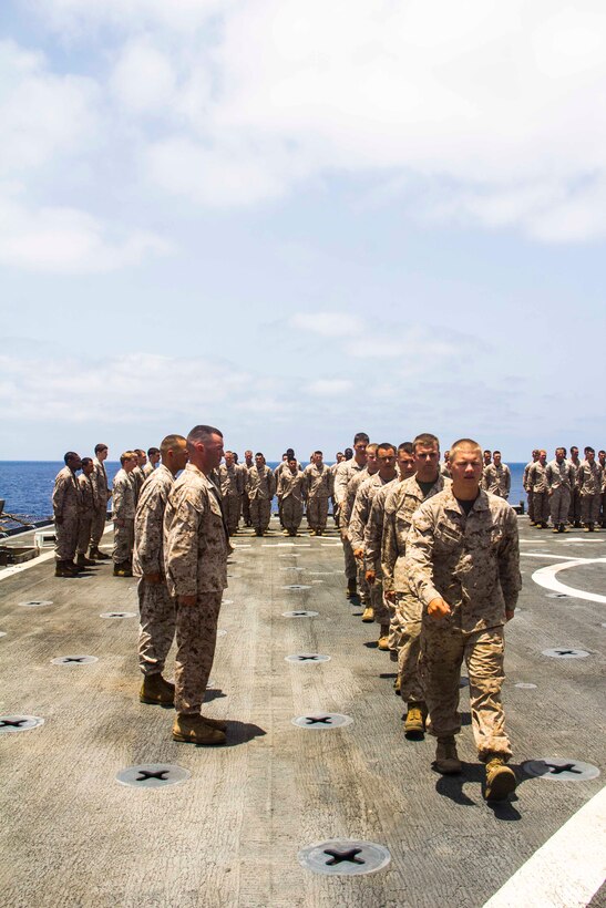 Capt. Raymond Kaster, Company K commanding officer, Battalion Landing Team 3/2, 26th Marine Expeditionary Unit (MEU), promotes Marines of Company K aboard the USS Carter Hall (LSD 50) while at sea May 5, 2013. The 26th MEU is currently deployed as part of the Kearsarge Amphibious Ready Group to the 5th Fleet area of responsibility. The 26th MEU operates continuously across the globe, providing the president and unified combatant commanders with a forward-deployed, sea-based quick reaction force. The MEU is a Marine Air-Ground Task Force capable of conducting amphibious operations, crisis response, and limited contingency operations.
(U.S. Marine Corps photo by Cpl. Michael S. Lockett/Released)