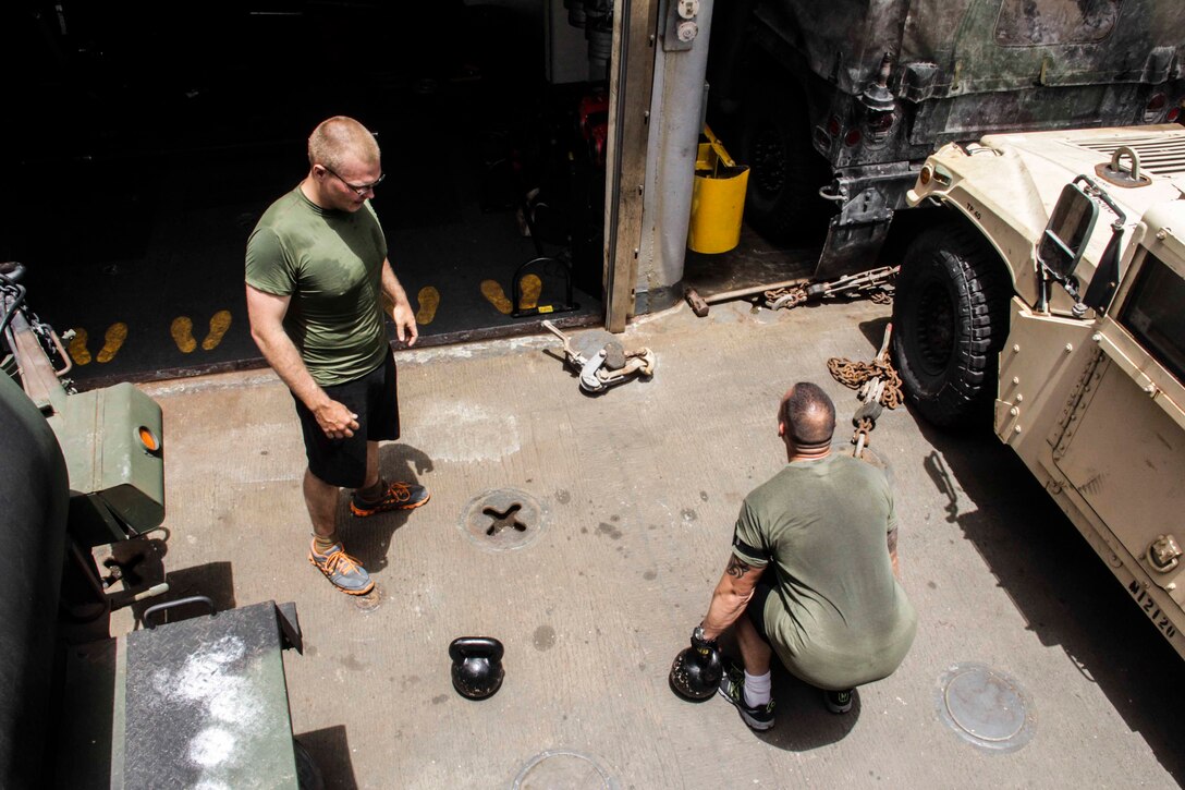 1st Sgt. Derrick Cordova, right, Company K first sergeant, Battalion Landing Team 3/2, 26th Marine Expeditionary Unit (MEU) demonstrates a kettlebell lift during a workout aboard the USS Carter Hall (LSD 50) while at sea May 9,2013. The 26th MEU is currently deployed as part of the Kearsarge Amphibious Ready Group to the 5th Fleet area of responsibility. The 26th MEU operates continuously across the globe, providing the president and unified combatant commanders with a forward-deployed, sea-based quick reaction force. The MEU is a Marine Air-Ground Task Force capable of conducting amphibious operations, crisis response, and limited contingency operations.
(U.S. Marine Corps photo by Cpl. Michael S. Lockett/Released)
