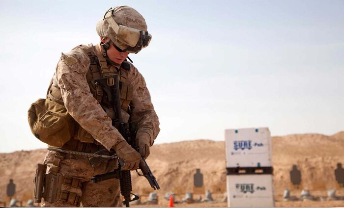 U.S. Marine Corps Cpl. Brady Fore, from Chapel Hill, N.C., assigned to Afghan National Civil Order Police Kandak 1 Advisor Team, Regimental Combat Team 7, checks the condition of his M9 Beretta pistol while conducting small arms live fire training on Camp Leatherneck, Helmand province, Afghanistan, April 25, 2013.