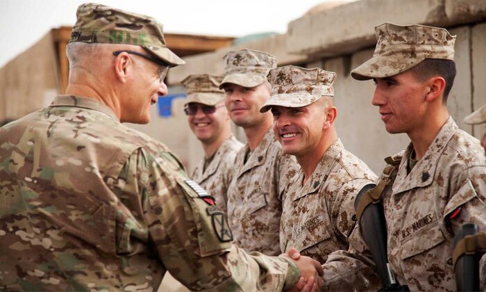 U.S. Army Lt. Gen. James L. Terry, commander, International Security Assistance Force Joint Command, presents a challenge coin to U.S. Marine Corps Sgt. Ignacio Zamarron, assigned to Headquarters Company, Regimental Combat Team 7 on Camp Leatherneck, Afghanistan, April 22, 2013.