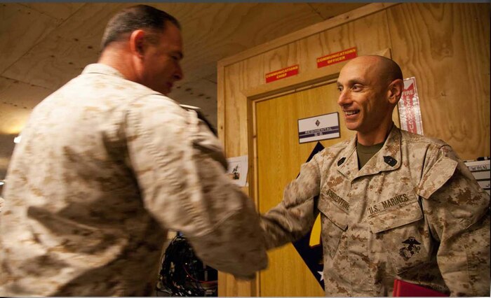U.S. Marine Corps Master Gunnery Sgt. Ron Sorrentino assigned to Headquarters Company, Regimental Combat Team 7, is congratulated following his reenlistment on Camp Leatherneck, Helmand province, Afghanistan, April 30, 2013.