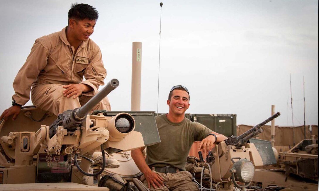 U.S. Marine Corps Lance Cpl. Phillip Lim, left, and Cpl. Brandon Baber, both assigned to Delta Company, 1st Tank Battalion, Regimental Combat Team 7, take a pause from conducting function checks on an M1A1 Abrams tank on forward operating base Shir Ghazay, Helmand province, Afghanistan, April 25, 2013.