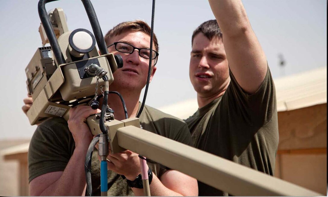 U.S. Marine Corps Lance Cpl. Zachary Schaible, left, and Cpl. Andrew Sanders, assigned to Headquarters Company, Regimental Combat Team 7, set up Secure Internet Protocol and Non-secure Internet Protocol Router Access Point (SNAP) satellite communications system on Camp Leatherneck, Helmand province, Afghanistan, April 24, 2013.