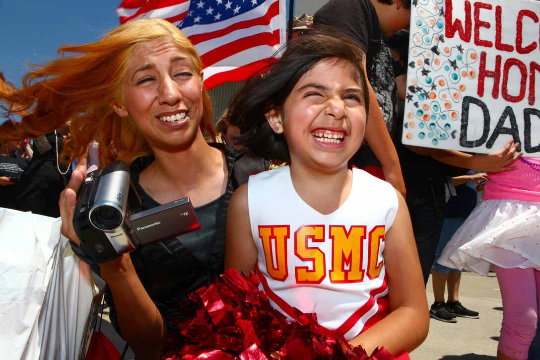 Rosie Herrera, left, and Precious, right, her 9-year-old daughter, can't stop smiling during a homecoming ceremony aboard Marine Corps Air Station Camp Pendleton, Calif., May 13. Rosie's husband's deployment with Marine Medium Helicopter Squadron 364 "Purple Foxes", 15th Marine Expeditionary Unit, represented the last deployment of Marine Corps CH-46 Sea Knight helicopters.