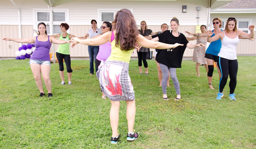 Erin Young, a Tahitian Zumba instructor, leads spouses in a Tahitian Zumba class during the Empowered Spouses Event at Mololani Community Center, May 10, 2013. Approximately 90 military spouses gathered at Mololani Community Center for the Empowered Spouses Event, where they took advantage of a series of workshops and a resource fair. (U.S. Marine Corps photo by Kristen Wong)