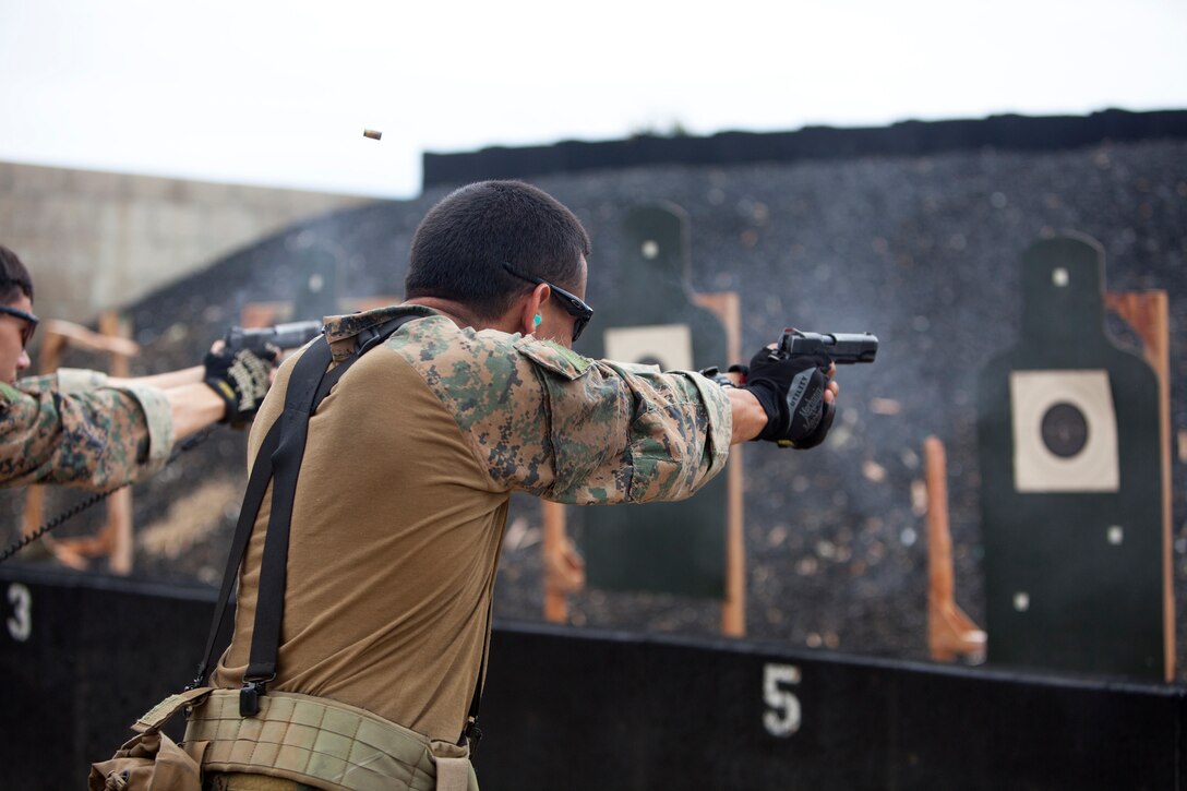 MARINE CORPS BASE HAWAII - Sgt. Timothy Hippler, a point man with force reconnaissance platoon, shoots a .45-caliber pistol during close quarter tactics shooting at Kaneohe Bay range training facility, May 13. (U.S. Marine Corps photo by Lance Cpl. Suzanna Lapi) 