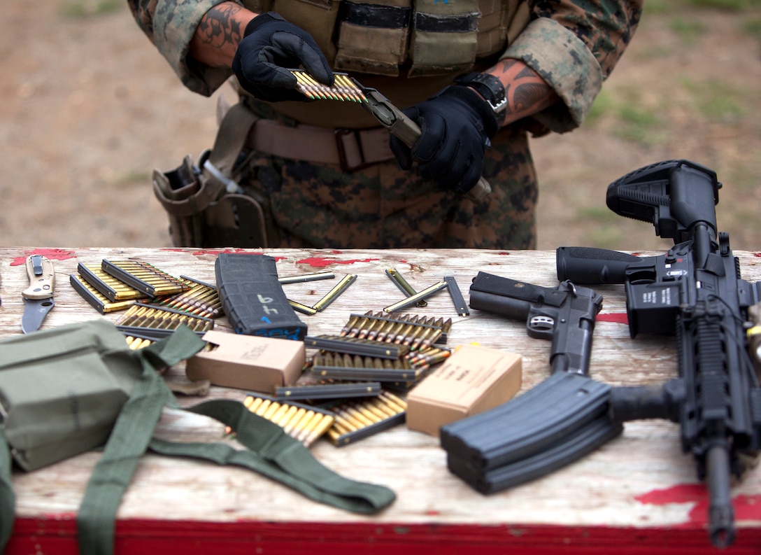 MARINE CORPS BASE HAWAII - A Marine from force reconnaissance platoon loads rounds into a magazine during close quarter tactics shooting at the Kaneohe Bay range training facility, May 13. (U.S. Marine Corps photo by Lance Cpl. Suzanna Lapi) 
