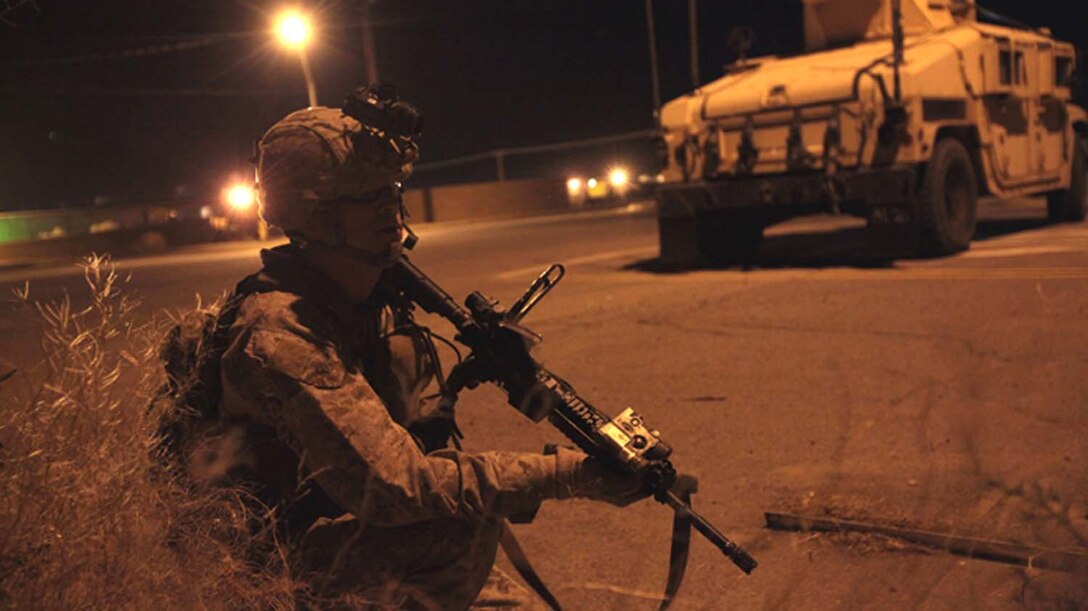 May 13, 2013: Capt. Matthew McCue, platoon commander the 13th Marine Expeditionary Unit and San Diego native, coordinates security from a blocking position during a training raid in Brawley, Calif., as part of Ground Realistic Urban Training.