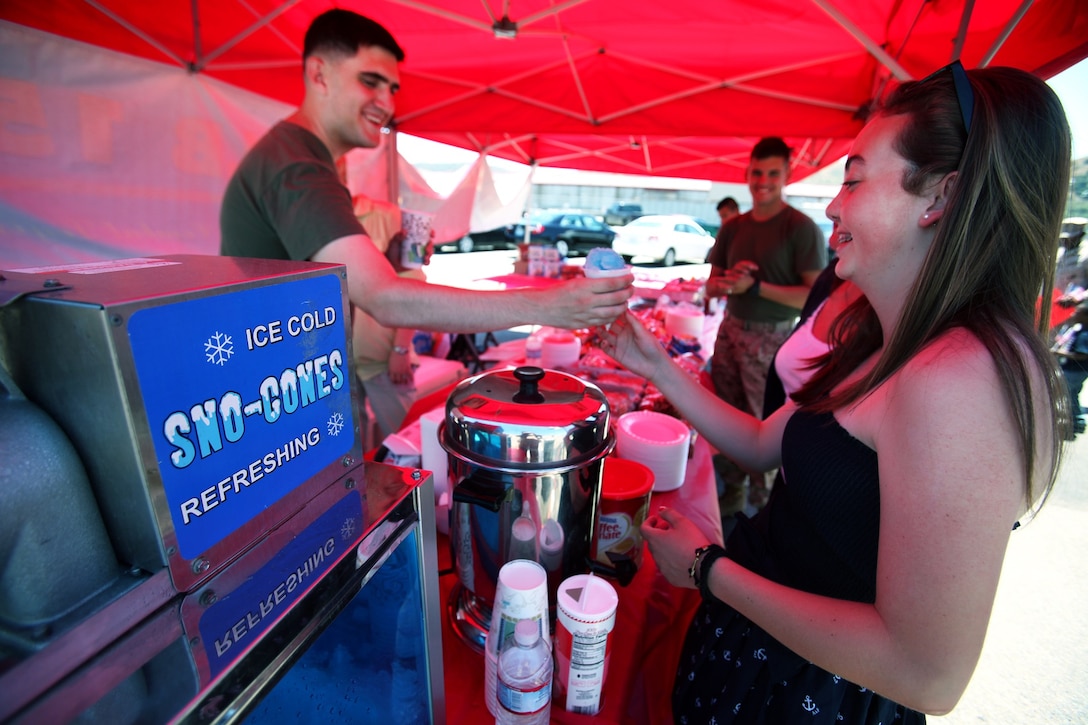Cpl. Bret Harrison, a maintenance specialist with Combat Logistics Battalion 15, 1st Marine Logistics Group, passes out snow cones during CLB-15’s homecoming aboard Camp Pendleton, Calif., May 13, 2013. Several Marines and sailors returned from an eight-month deployment with the 15th Marine Expeditionary Unit. 